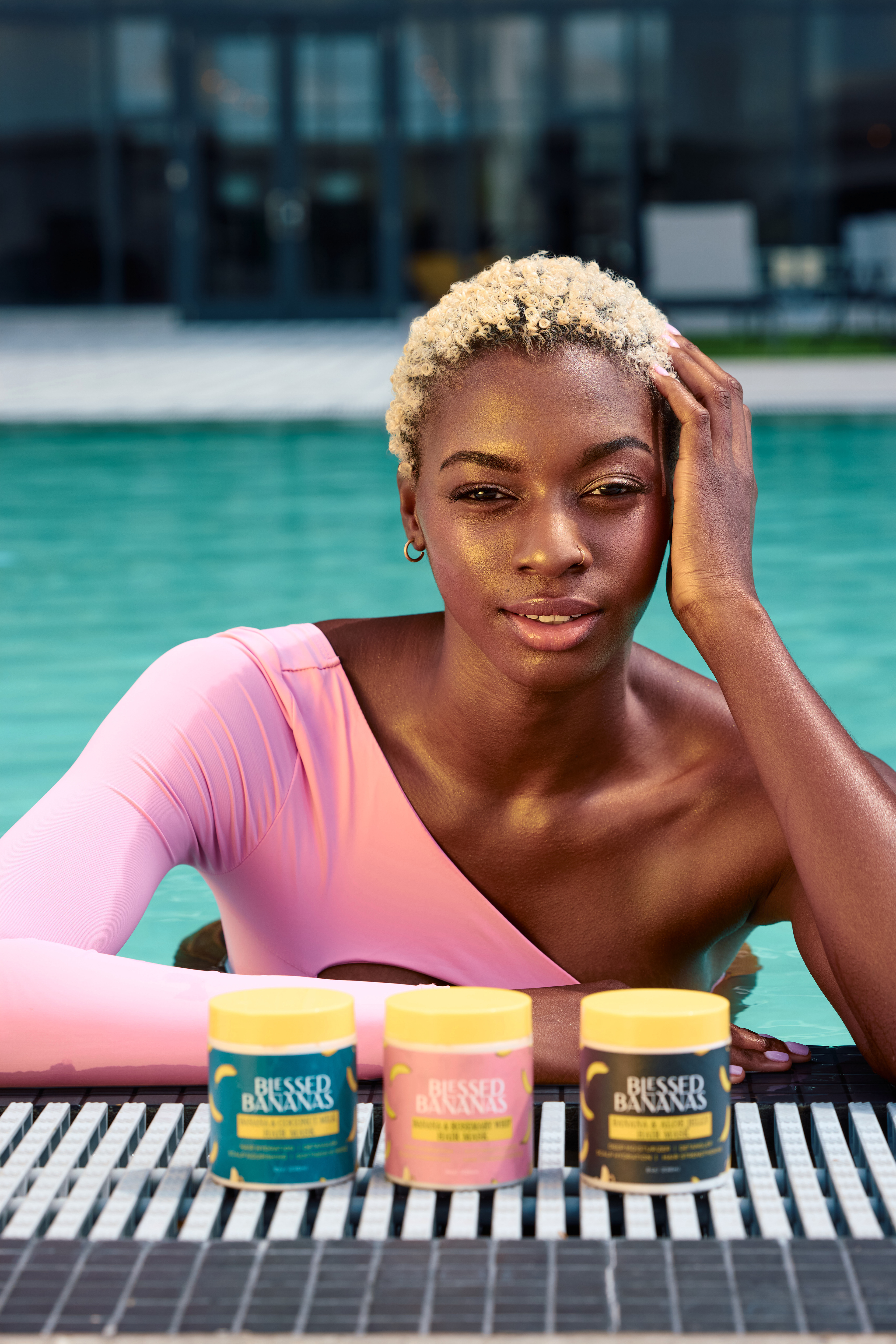 Poolside beauty portrait featuring Blessed Bananas haircare products.