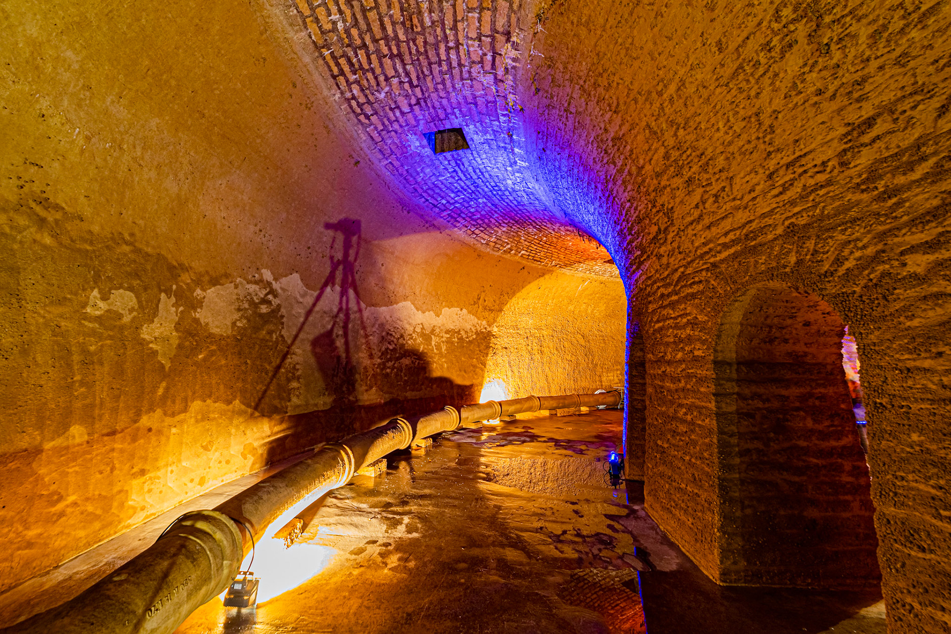 Visite de la salle voutée du réservoir Darcy, vidé une fois par an pour sa maintenance et les visites. Murs en pierres. Mise en lumière.