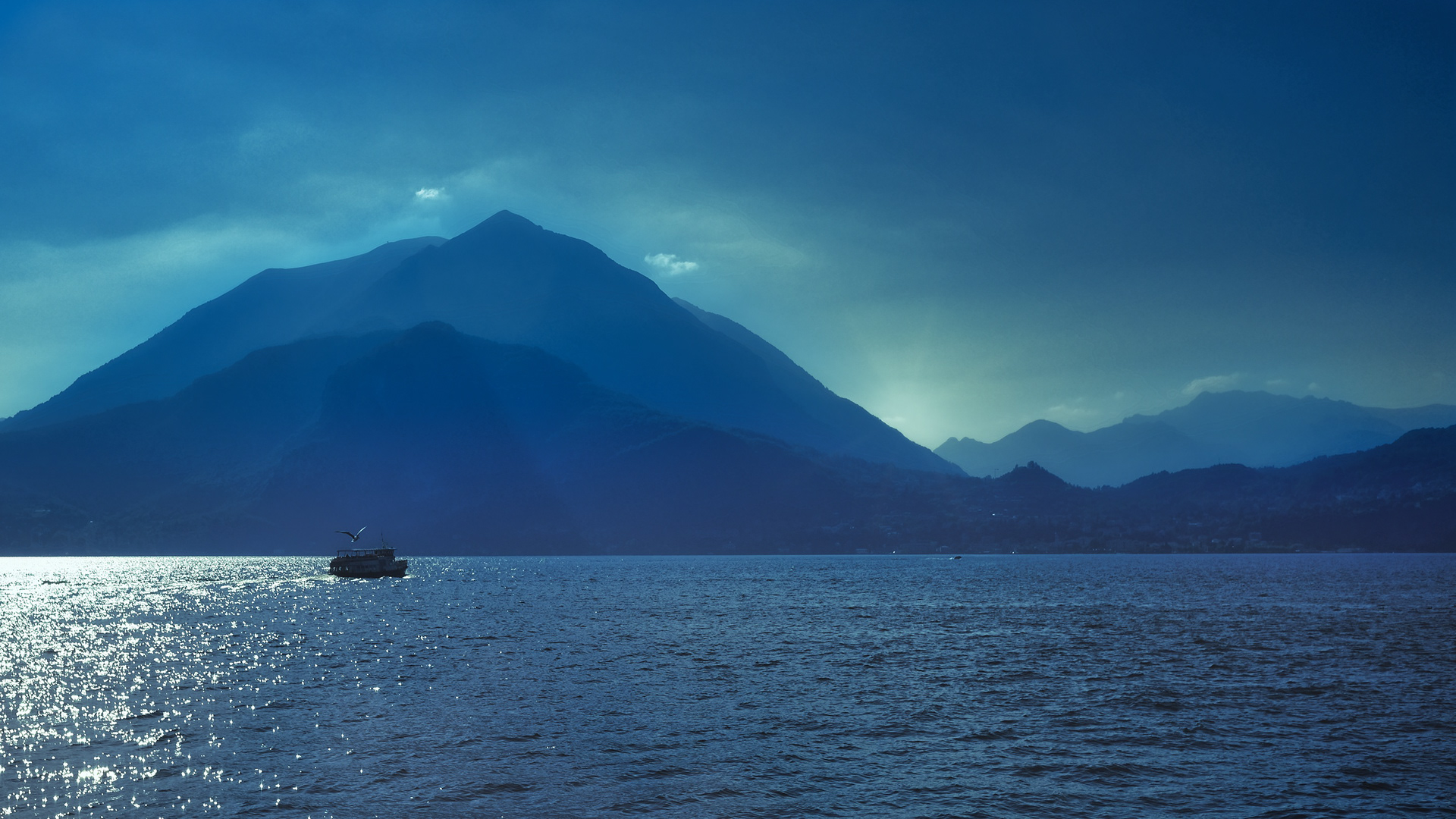 On Como as the sun sets behind the mountains.