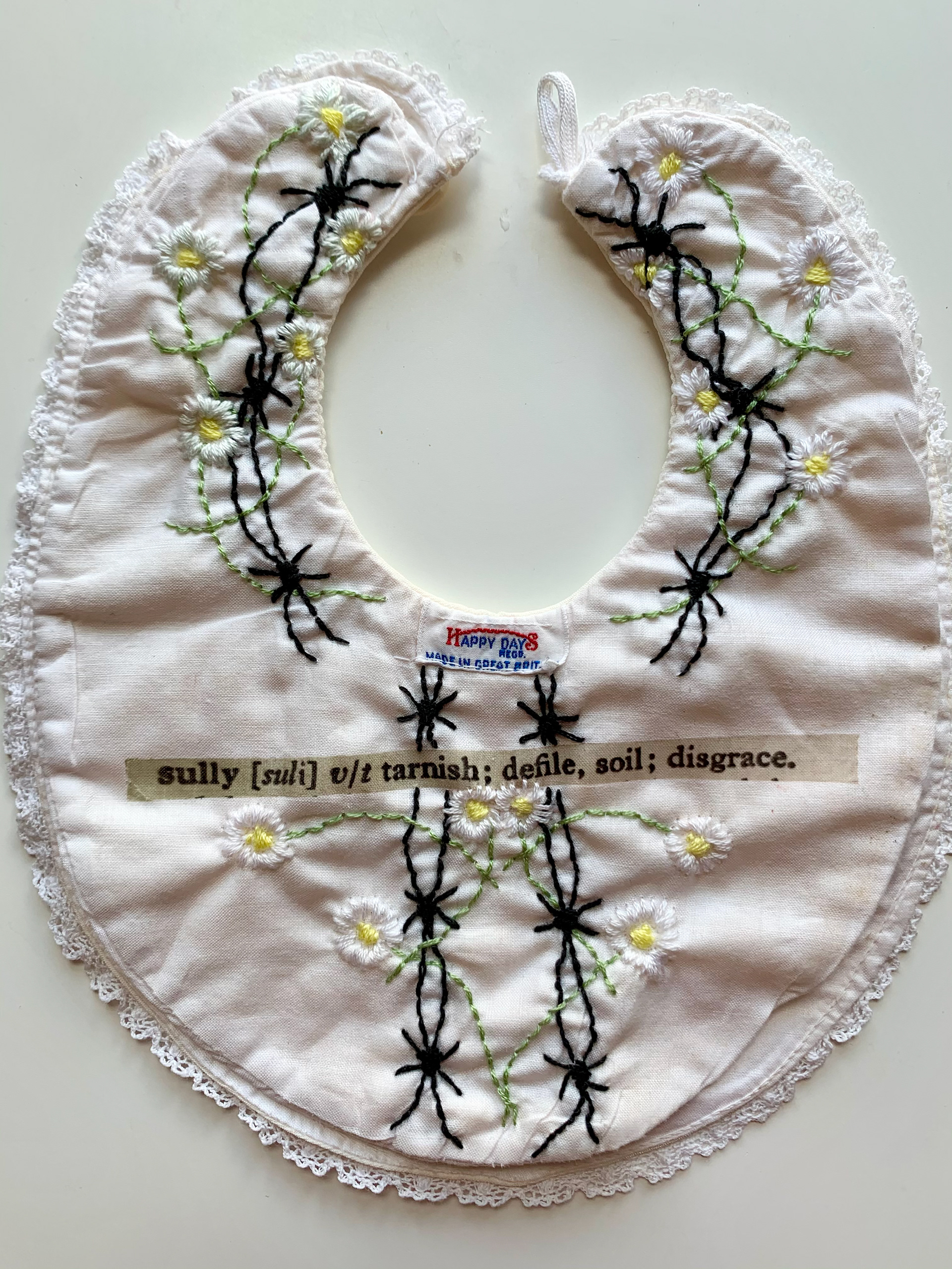 ‘’Sully’’ Tracy Davidson, textiles, 2020 ‘’ Printed dictionary definition and hand embroidery on vintage bib. 25x23cm’’ @tracy_davidson_textile_artist
