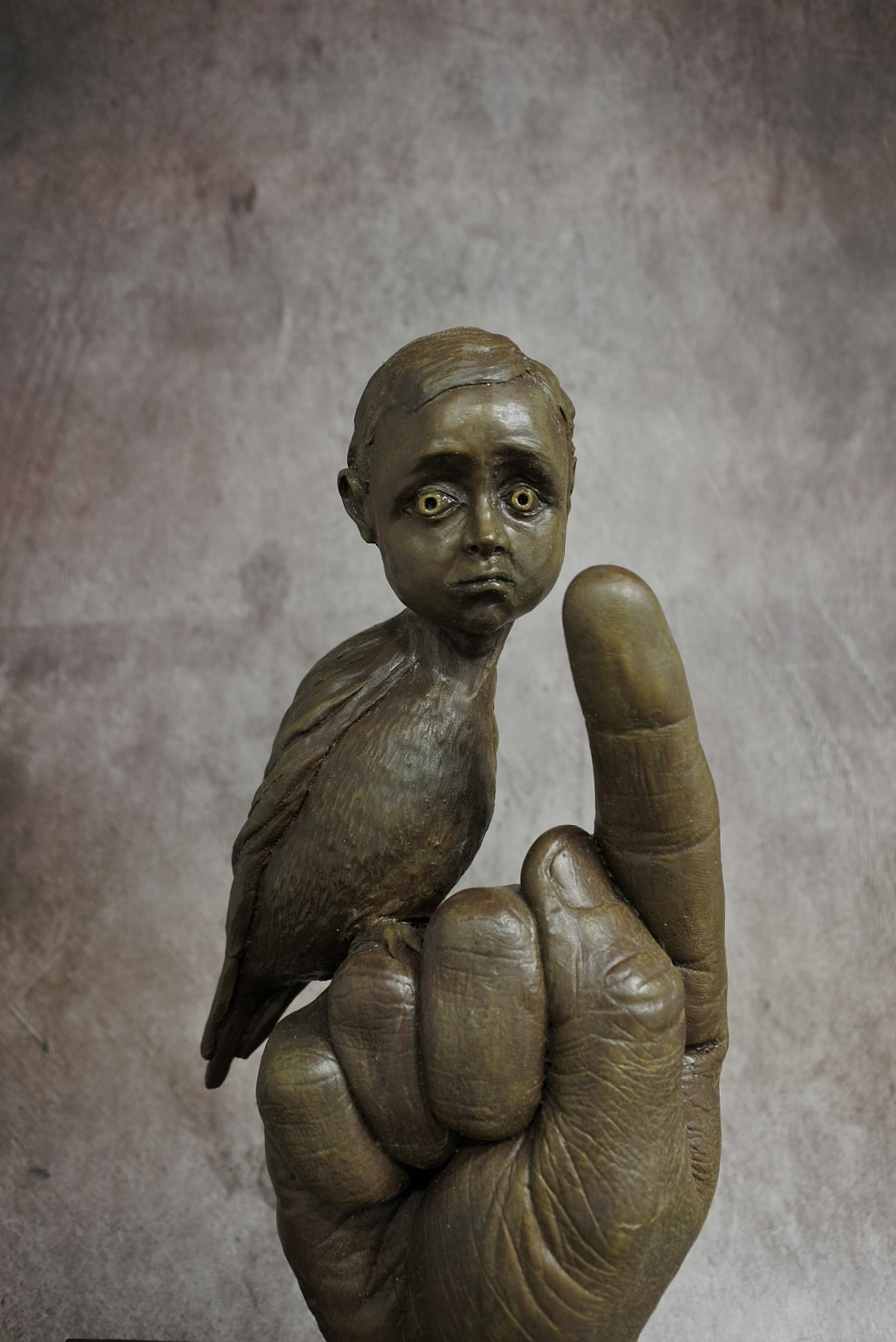 ’Expectations’’ Pete Donnelly, sculpture, 2020 I am a Yorkshire based sculptor and work in a variety of different mediums including resin cast, mixed media and ceramic art. I have been developing various sculptures around the themes of social perceptions around mental health which have been inspired further by the impact of lock down which has served as both a difficult time for many and an opportunity for reflection. Both the ceramic method and the process of casting in resin are fairly long procedures which rely upon patience and an attention to detail. I have expanded upon an interest in traditional figurative sculpture and developed forms in order to represent reflections on the theme of mental health, confidence and the many associated contradictions present with the human psyche. My work is generally based around the human form, however I often manipulate this image in order to serve modern themes, most prominently mental health and the complexity of the human condition. My aim is to communicate fragments of this complex picture in a way which prompt the viewer to reflect upon their own thoughts and opinions on the subject. This piece is called “Expectations” it stands at 270mm and is a combined resin sculpture and body cast using two separate moulding techniques. The child’s face serves as an expression of vulnerability and apprehension on the body of a bird which reflects the potential for freedom and independence. The hand serves as a presence of authority, firmly directing the subject towards the expected pathway. www.peterdonnelly.co.uk Instagram: @titanic_pete Facebook: https://www.facebook.com/titanicpete