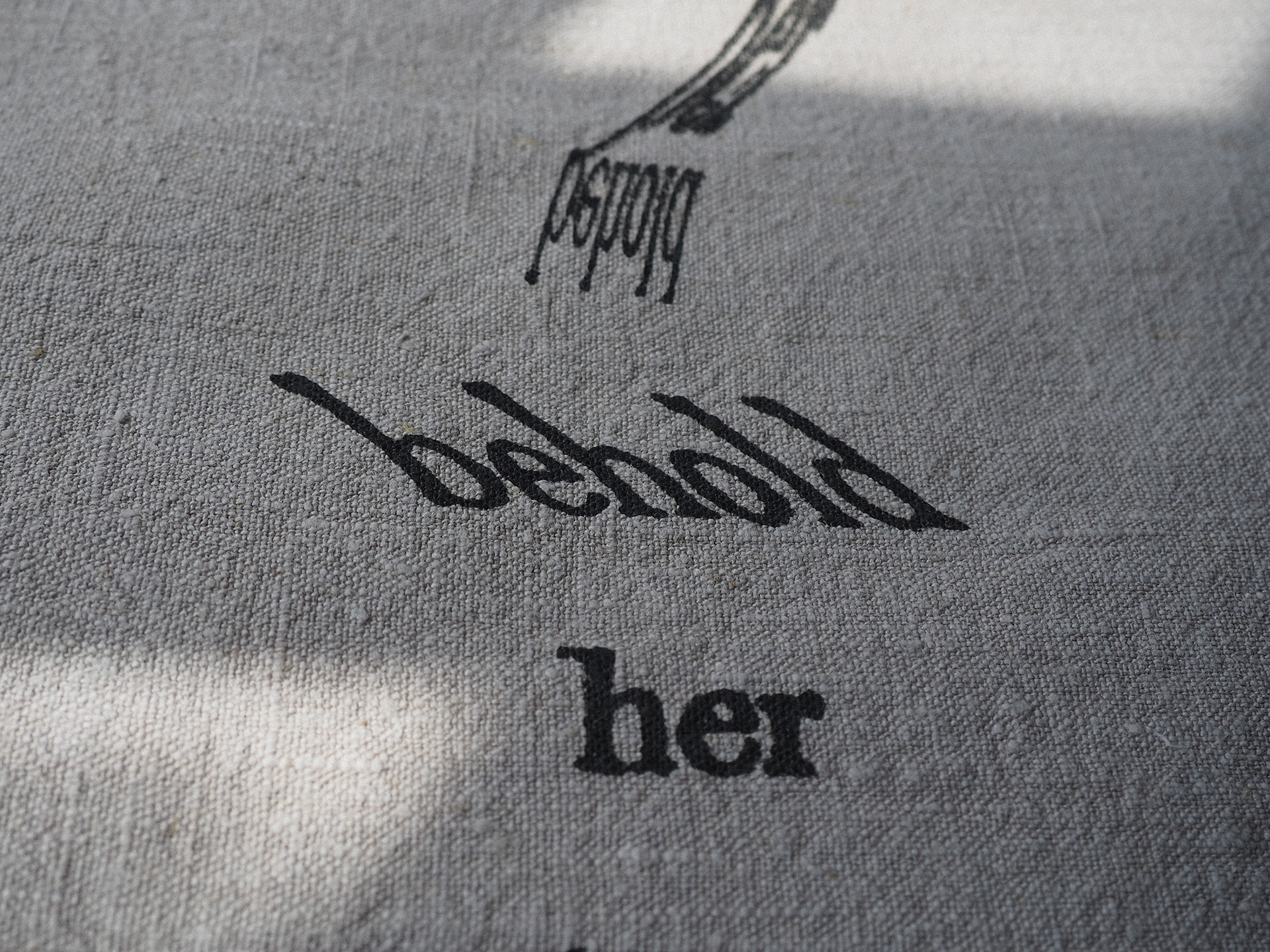 “Bioregional Dialect: Automatic Verse in Iron Gall Ink” Helen Armstrong, Textile/Screen-print/Pigment Making, 2026 “A selection from an extensive series of cut-up poems that have been screen-printed onto raw organic linen using a historically accurate adaptation of a 16th-century iron gall ink recipe.  (more info on my website https://helencarmstrong.com/projects/bioregional-dialect-iron-gall-ink and also https://helencarmstrong.com/projects/irongallink)  This work is a text-based inquiry that employs the cut-up technique and a combination of digital and analogue manipulation to destabilise and reconfigure an archaic text.  Utilising a re-creation of a historic ink made from locally foraged oak galls to carry the words, the process opens up opportunities for dialogue with unauthored voices. By deconstructing and reassembling source material, an opportunity arises to peer behind the veil between personal perception and non-human agency. Through this process, ultimate control over the outcome is surrendered to facilitate the becoming of chaos, randomisation, and the other, inviting the beholder to decode a broken language.” https://helencarmstrong.com 