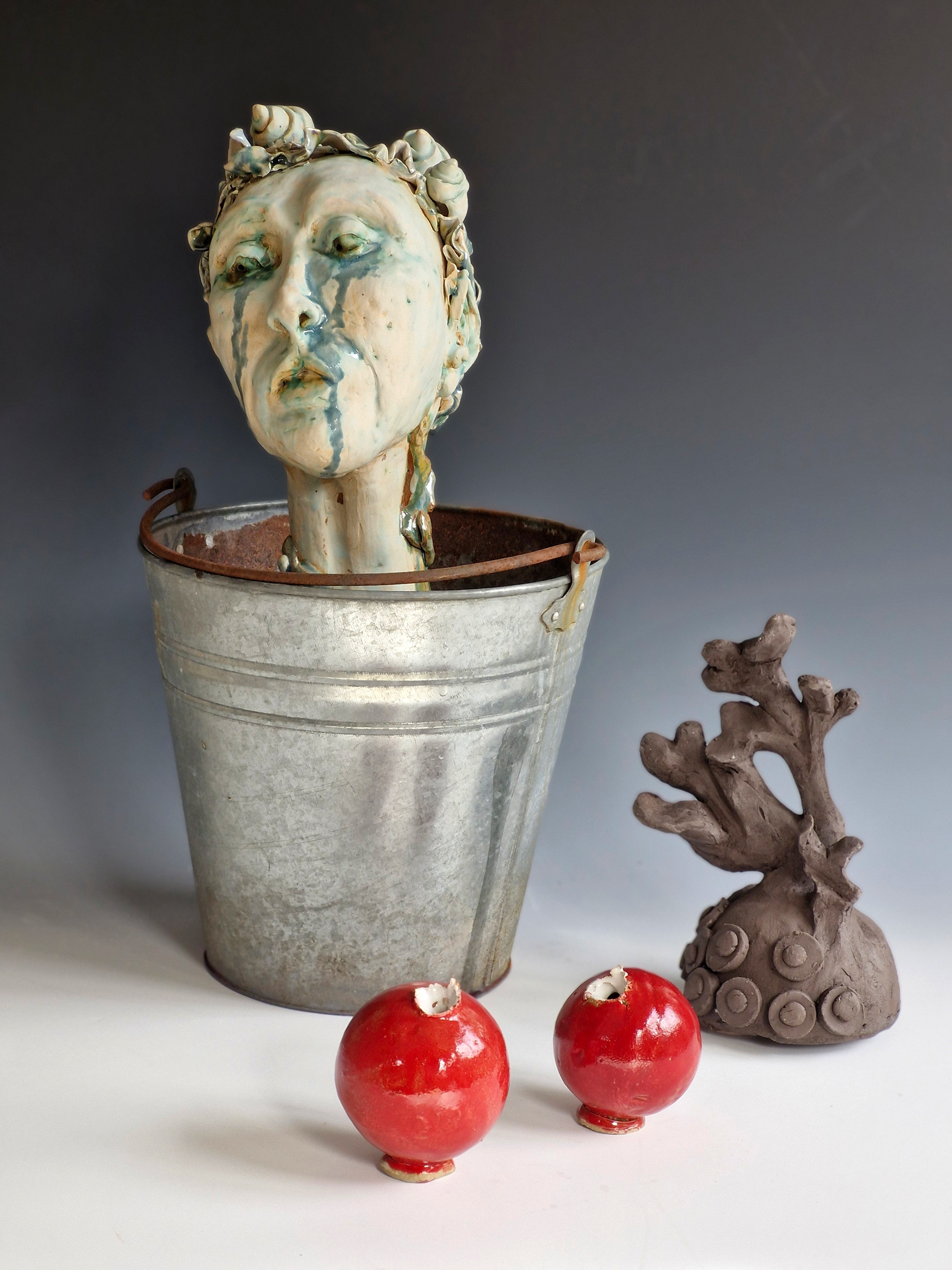 “Shed Salty Tears” Helen Birnbaum, Ceramic and reclaimed media, 2023 “In 2023, 480,343 pieces of litter were found on UK beaches, by 2024 this had become 764,451.. The fish, marine animals and birds that become caught in plastic rubbish suffocate, stave and drown: hundreds of marine species have been harmed by the debris we leave in our oceans. As our planet faces greater and greater environmental problems I strive to create work that combines important ecological messages alongside sustainable practice. Shed Salty Tears draws attention to the bleaching of the sea bed and pollution and consists of many ceramic pieces which are integrated with found objects.  Calling us to take notice of this environmental crisis is the statue of a woman at the centre of the ceramic installation Shed Salty Tears; the voice of the planet, calling us to notice the state of our environment degraded by industrialisation. Crushed cans, rusty metal forms and discarded plastic cluster around the central sculptures. Reclaimed materials challenge viewers to consider what they consume and how it is discarded.  Shed Salty Tears is a triptych with each of the three separate sections having their own particular emphasis. Each section has approximately fifty white, grey and blue shells, corals and other sea life surrounding three large central sculpted figures; a telephone; an African harp and a crying figure shedding salty tears. In striking contrast brightly coloured ceramic made red, orange and green drinks cans, milk bottles and baked bean cans suggest the detritus causing damage to our seas and beaches.  Shed Salty Tears also includes a selection of bizarre sea creatures envisaged as part organic and part metal debris suggesting that because of the rubbish we throw into the sea this is what the creatures might even become - part organic matter and part the rubbish we humans have left behind.” helenbirnbaumceramics.com  @helenbirnbaumceramics