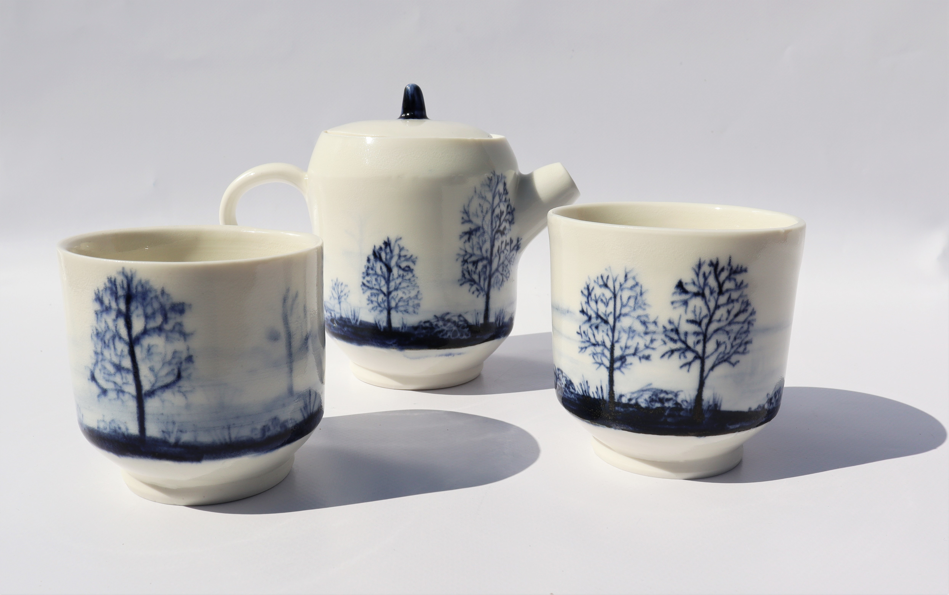 “Yorkshire Tea Flooded Field” Thrown Porcelain with Blue Slip, 12.5cm high by 16cm wide from handle to spout, Iona Stock www.imsceramics.com @ims_ceramics These pieces have been inspired by my walks around my local area during lockdown. I took my sketch book with me and after drawing on location I have then translated these drawings into designs suitable for ceramics. It was incredible seeing all the wonderful little spots so close to my home and really made me appreciate why I enjoy living in this part of the world. The pieces have then been hand thrown on my potter's wheel in my local studio and then the design is hand painted onto the surface in blue slip. I have really enjoyed the peacefulness that lockdown provided, giving me the time and space to really observe nature and the passing of time. I was in my final year of university when lockdown hit so moved back in with my parents and decided to set up my own studio and put my other plans on hold. I have made these into functional pieces as I want to share my little piece of paradise bringing joy to people's everyday lives which is even more important in these uncertain times. I feel that using local handmade items really enhances the experience whether that be a cup of tea or coffee either by yourself or a socially distanced catch up with a friend.
