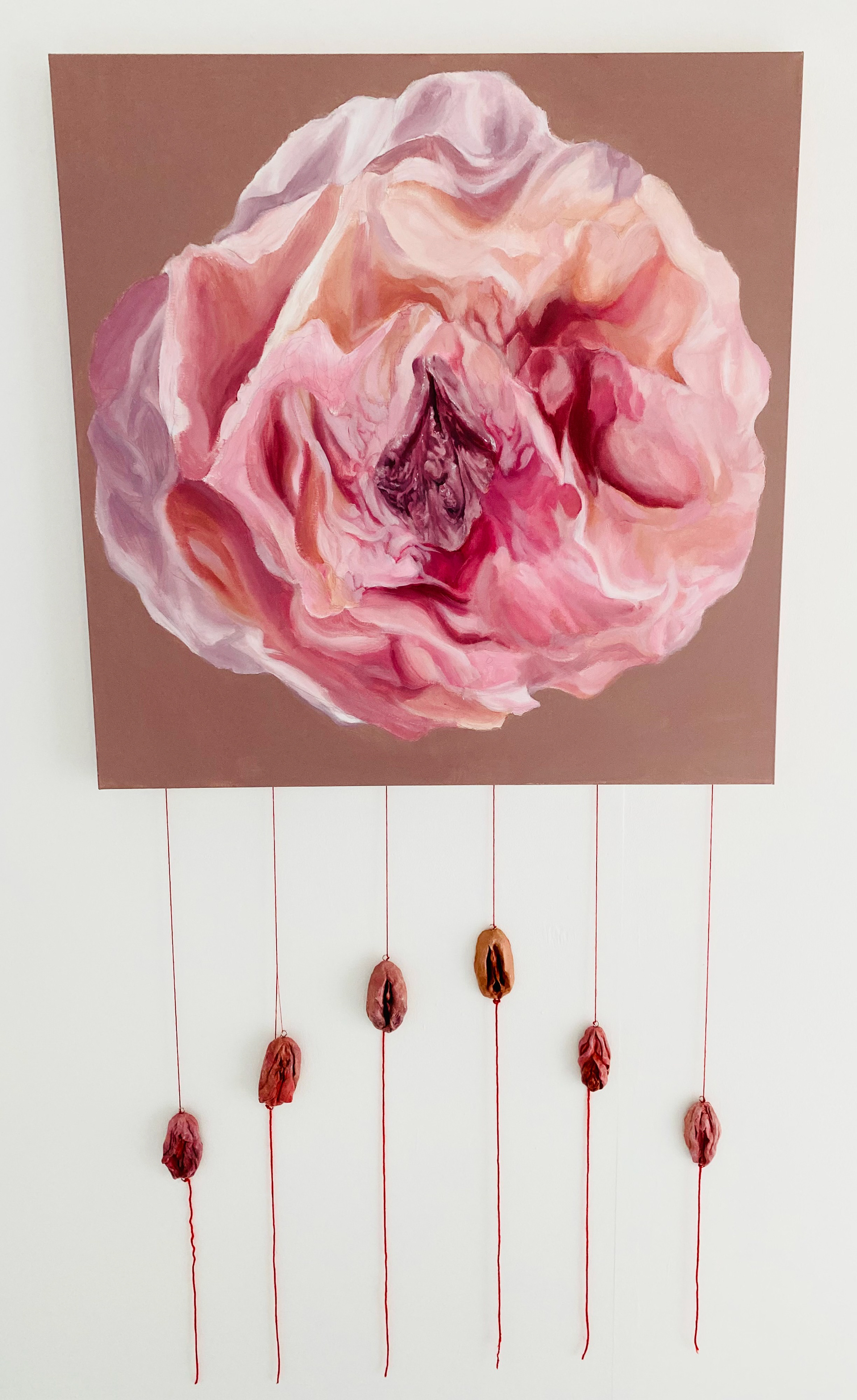 “Peony Pussy”, Caitlin Smith, 2022 Acrylic over stretched canvas with hand-sculpted air-dry clay vulvas which have been painted with acrylic, dry brushed with clear gloss and suspended by red yarn. 90 x 90 cm
