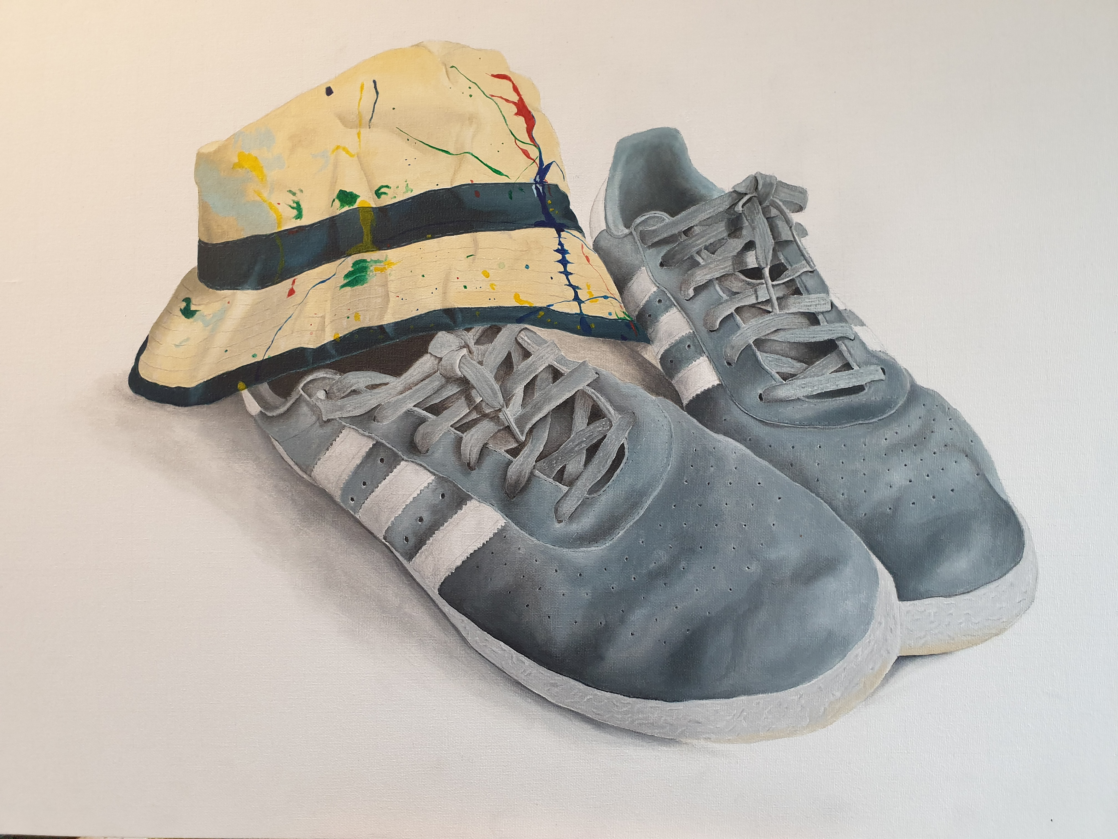 “Still life no.2”, Acrylic on Canvas Board, 76 x 51 cm Kevin Devonport @the_art_of_no_noise 76 x 51 cm Acrylic on canvas board. Realism painted with a minimalist background. Retro 1990 style trainers and Stone Roses Jackson Pollock paint style hat.