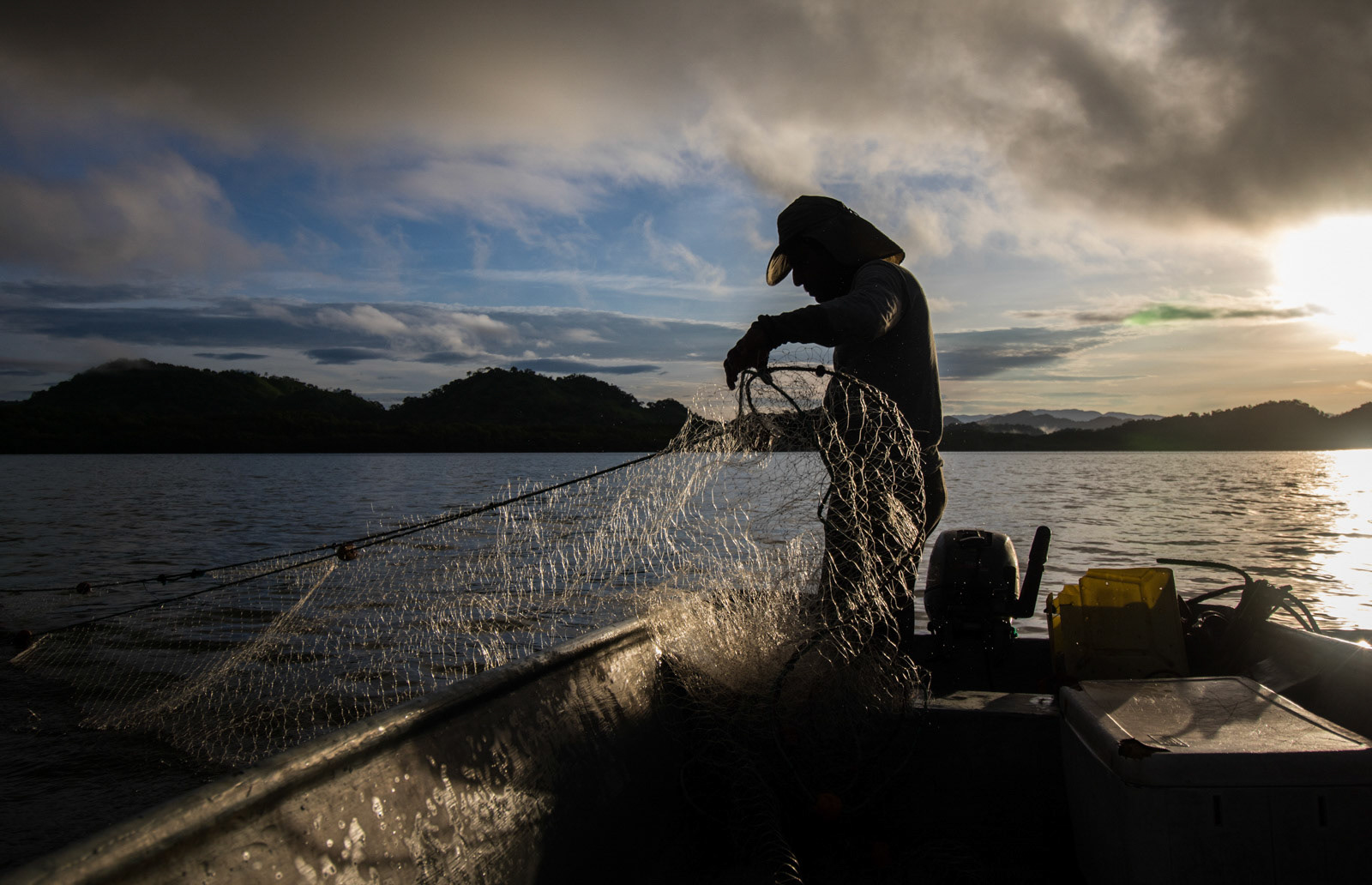 By sunrise, Umaña is out at sea fishing.