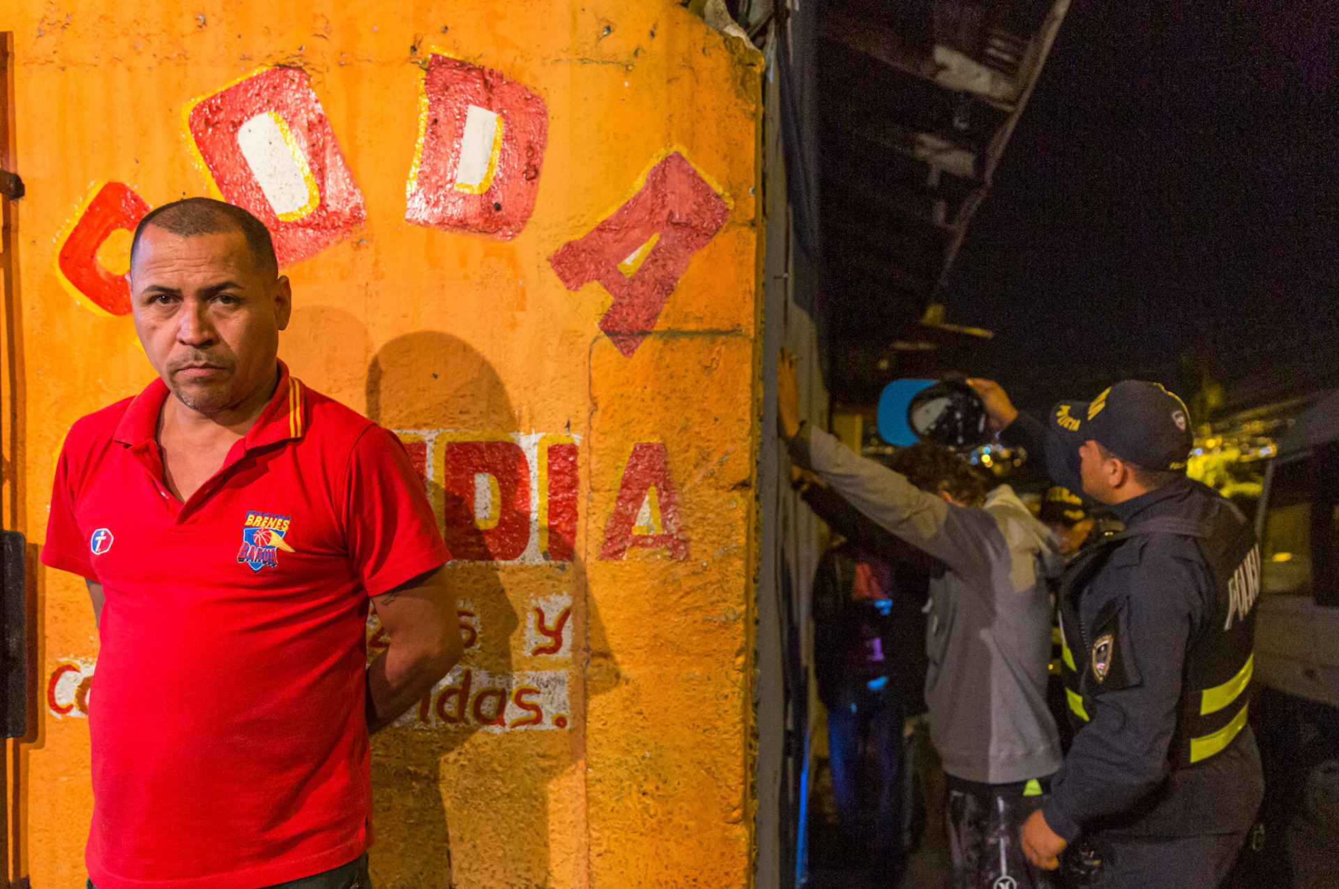Police searching men outside a soda in Pavas, one of the most violent districts in Costa RIca.