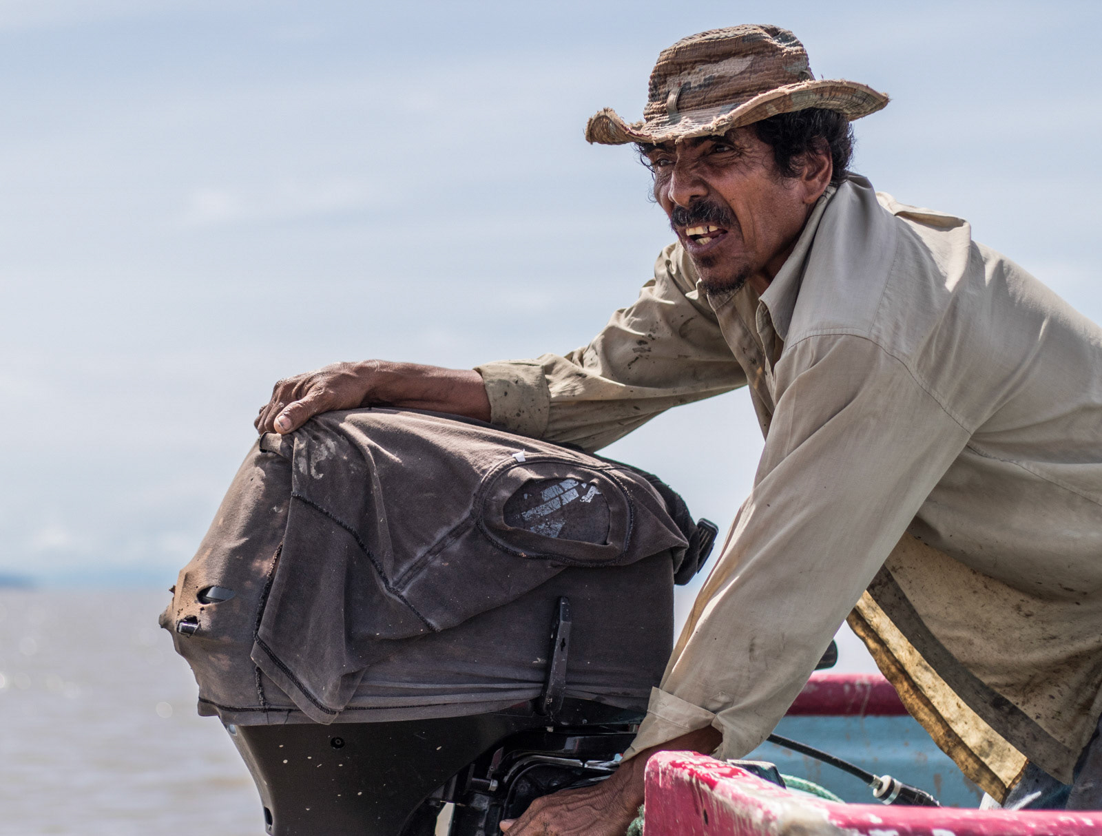A fisherman having trouble starting his engine.