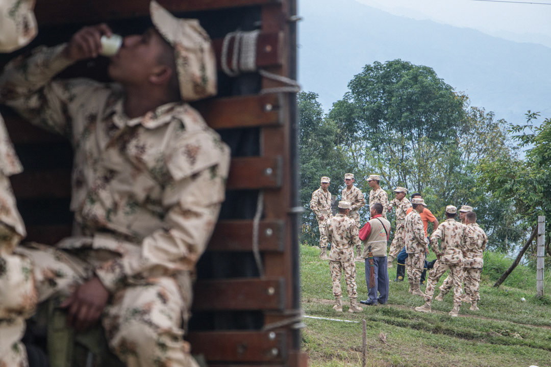 Unarmed members of the Colombian building a temporary shelter for demobilizing Farc fighters.