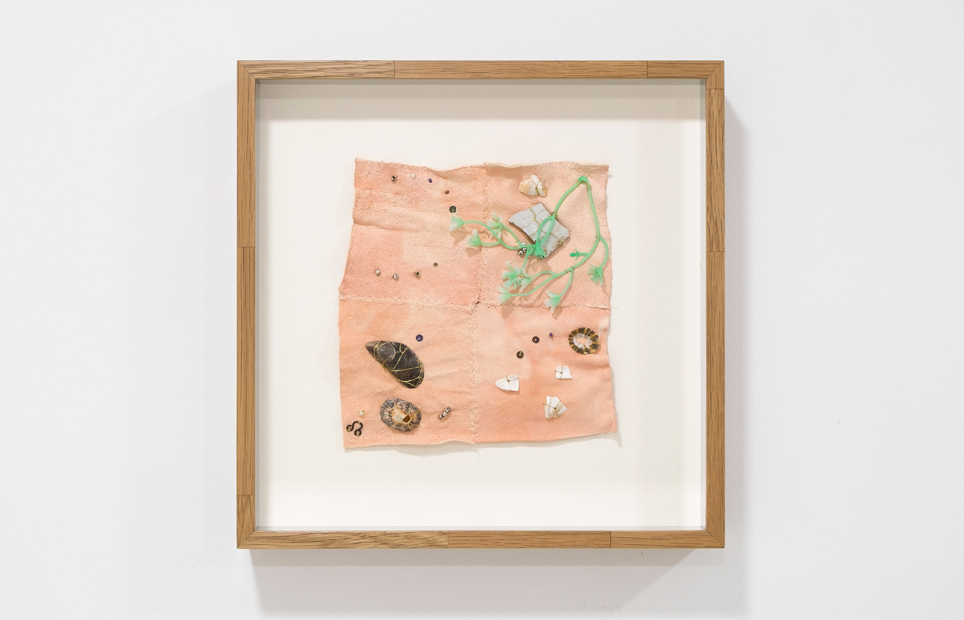 May Hands, Seaside Constellation (Pink Moon), 2022 Chamois cloth dyed with Madder root, ceramic fragment, hook and eye fragment, plastic foliage, shells, beads, sequins and gold thread. Constructed oak box frame with 5000 year-old black bog oak spline-joined corners. Polished aluminium glazing spacers. 27.4 x 27.4 x 4.2 cm (framed)