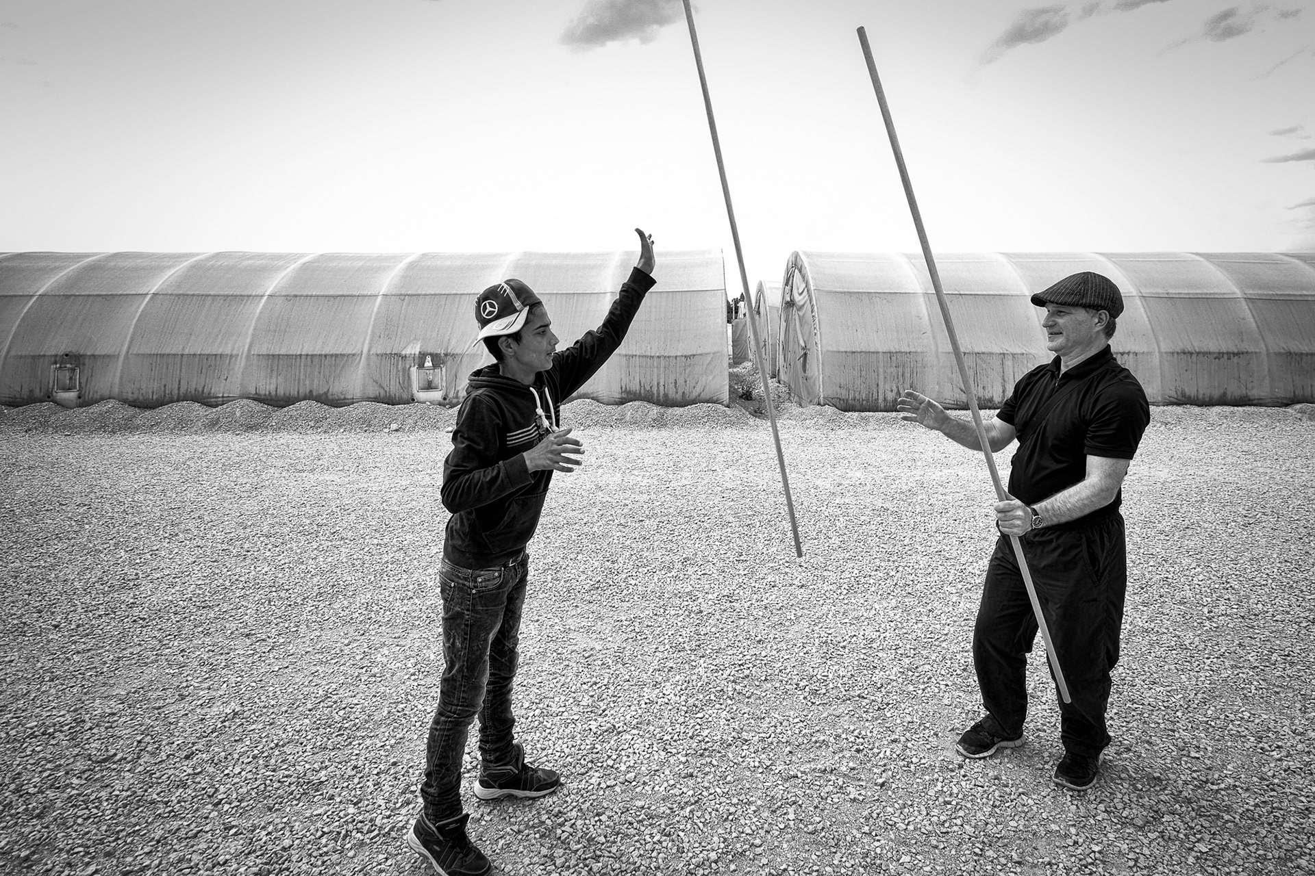 Wolfgang, the lead instructor is teaching a refugee boy the tricks if he wants to become a good stilt walker.