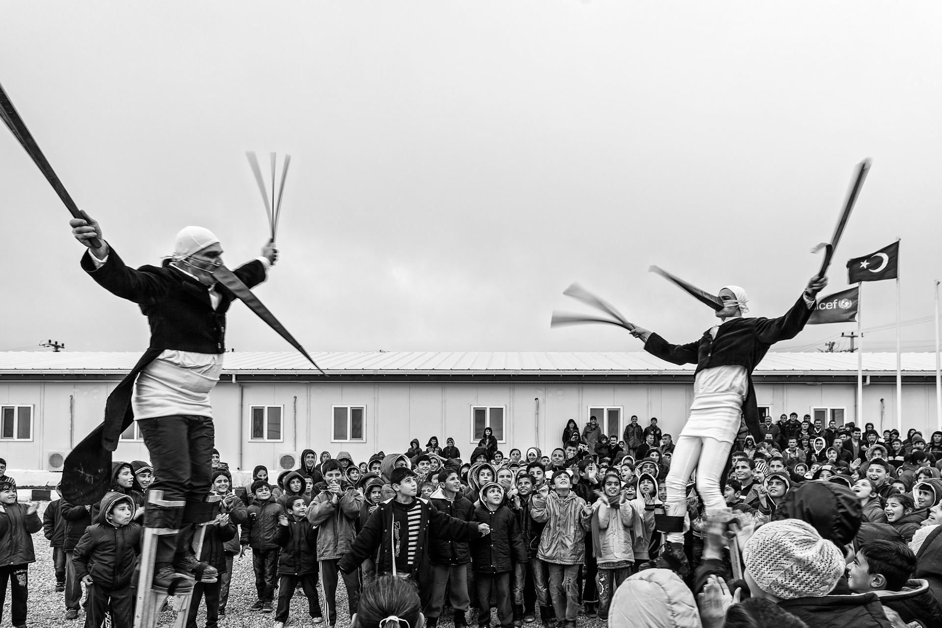 Instructors who were in the camp for training performs a stilt dance for all the refugee children in the Nusaybin refugee camp.