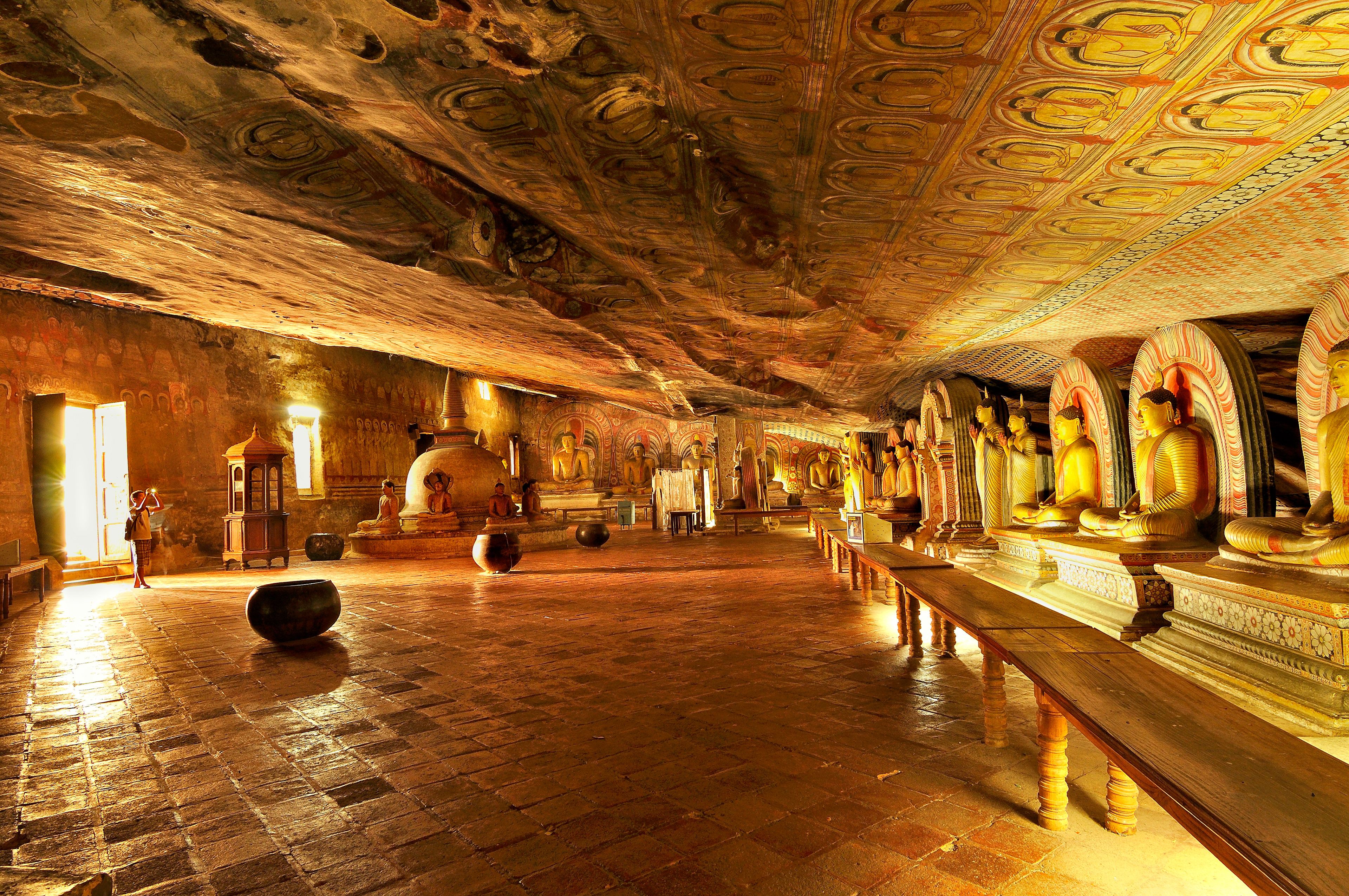 The magnificent golden ceiling and seated Buddha statues inside the Dambulla Cave Temple (Golden Temple), a UNESCO World Heritage site
