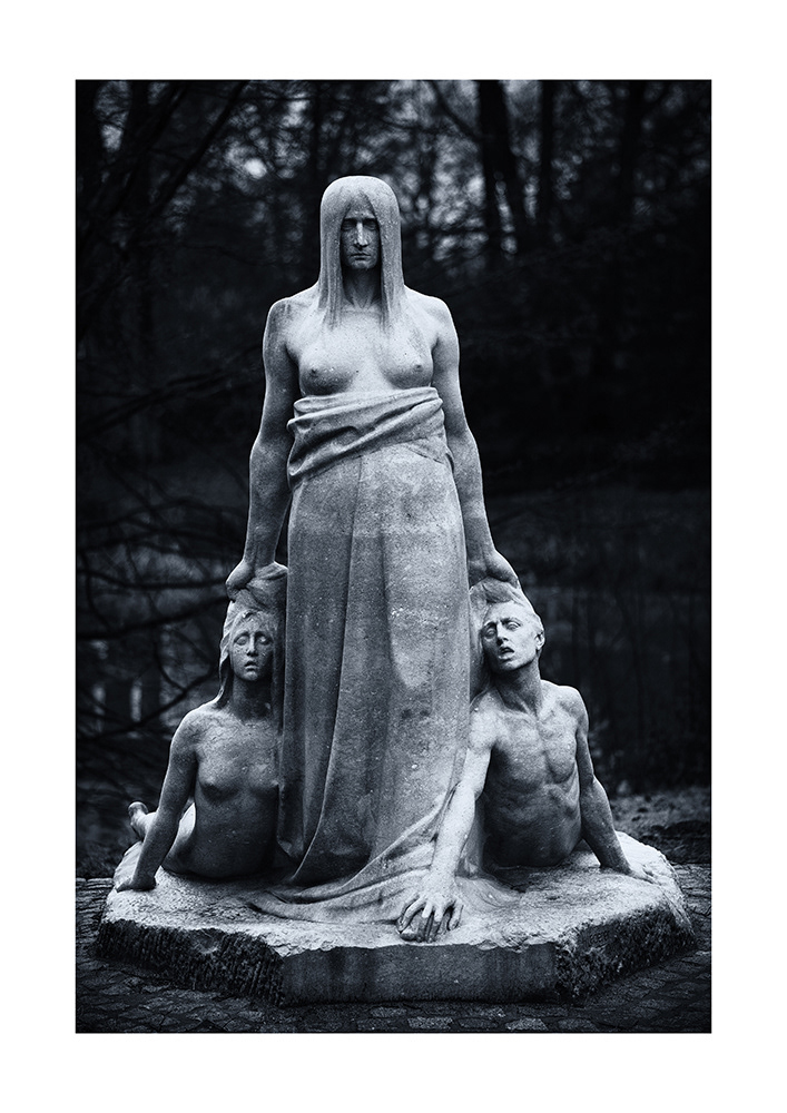 The bare-breasted fate strides darkly and inexorably onward, its hands grabbing a boy and a girl by the hair.