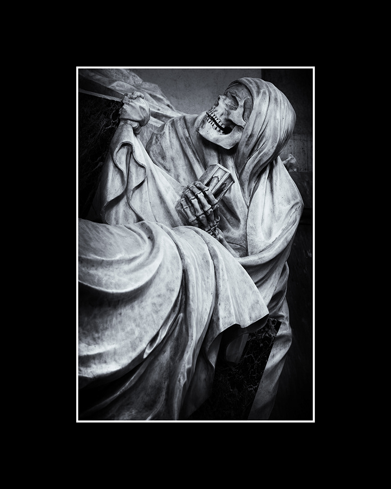Death, a terrifying skeleton shrouded in a hood and robe, steps out of a grave, holding an hourglass in its bony hand.