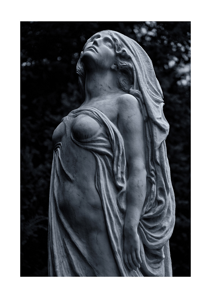 An elegiacally dressed woman dreams of heaven. Her body glows with light that emanates from without a direct light source.