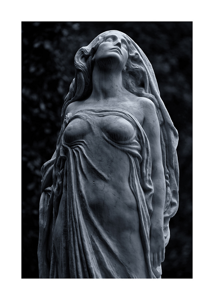 An elegiacally dressed woman dreams of heaven. Her body glows with light that emanates from without a direct light source.