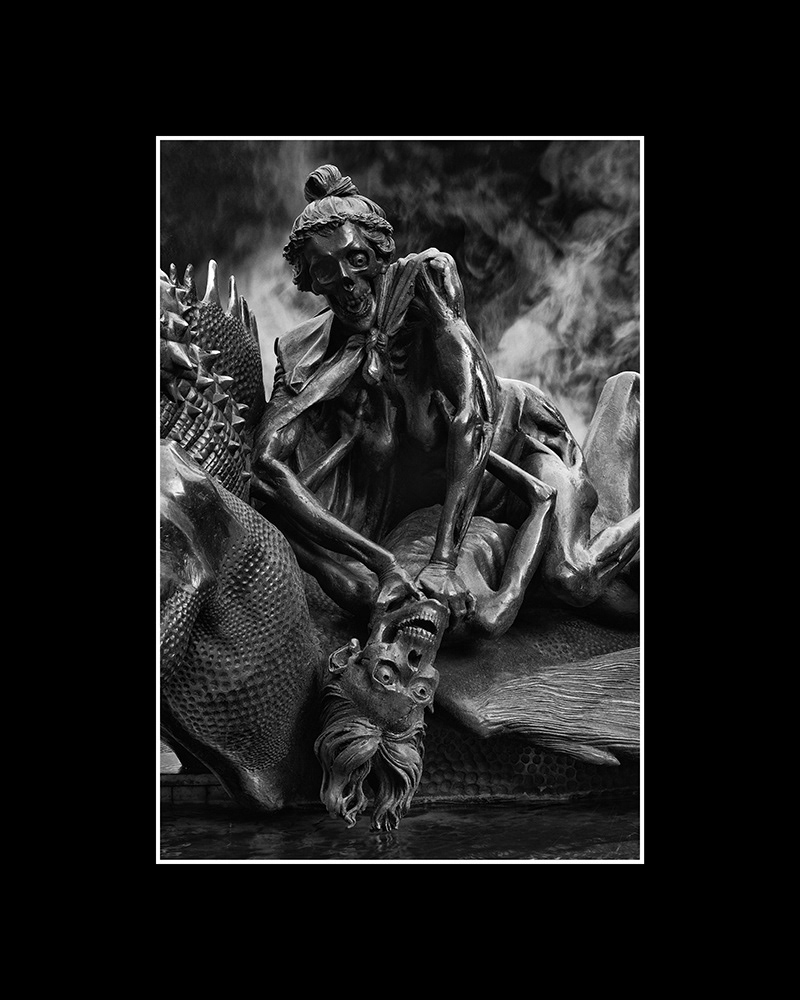 An elderly couple, half-skeletonized, wrestle with each other in a death struggle at a city fountain in Nuremberg.