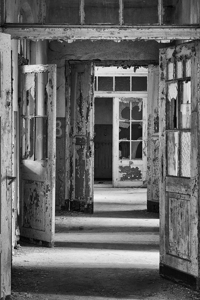 Hallway with peeling paint: Do the open doors represent the forks in the road of life? Do dark secrets lurk in the rooms?
