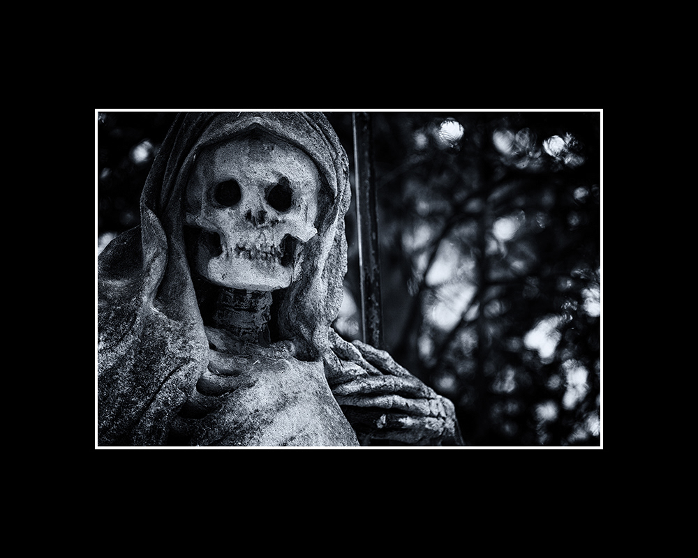 Death, dressed in a robe and hood, with a scythe in his bony hand, looks at us head-on with a heavily weathered face.