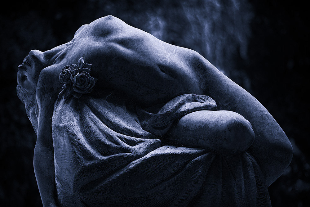 Sculpture of a female nude, lying on a boulder, draped with a rose, expressive eroticism.