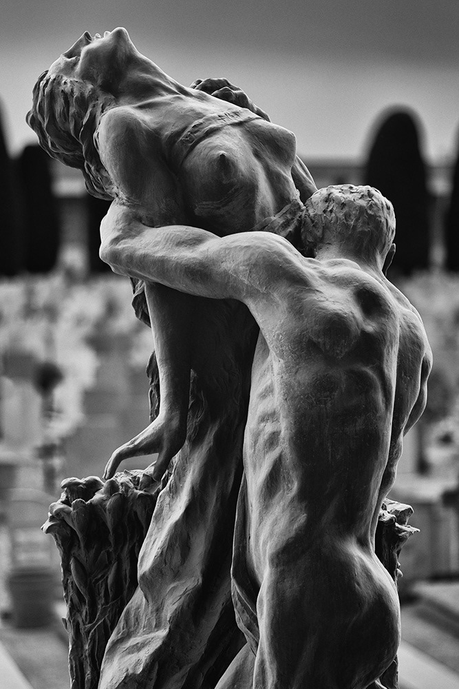 Final hug: A naked man clings to a young woman with bare breasts who is already reaching for the sky.