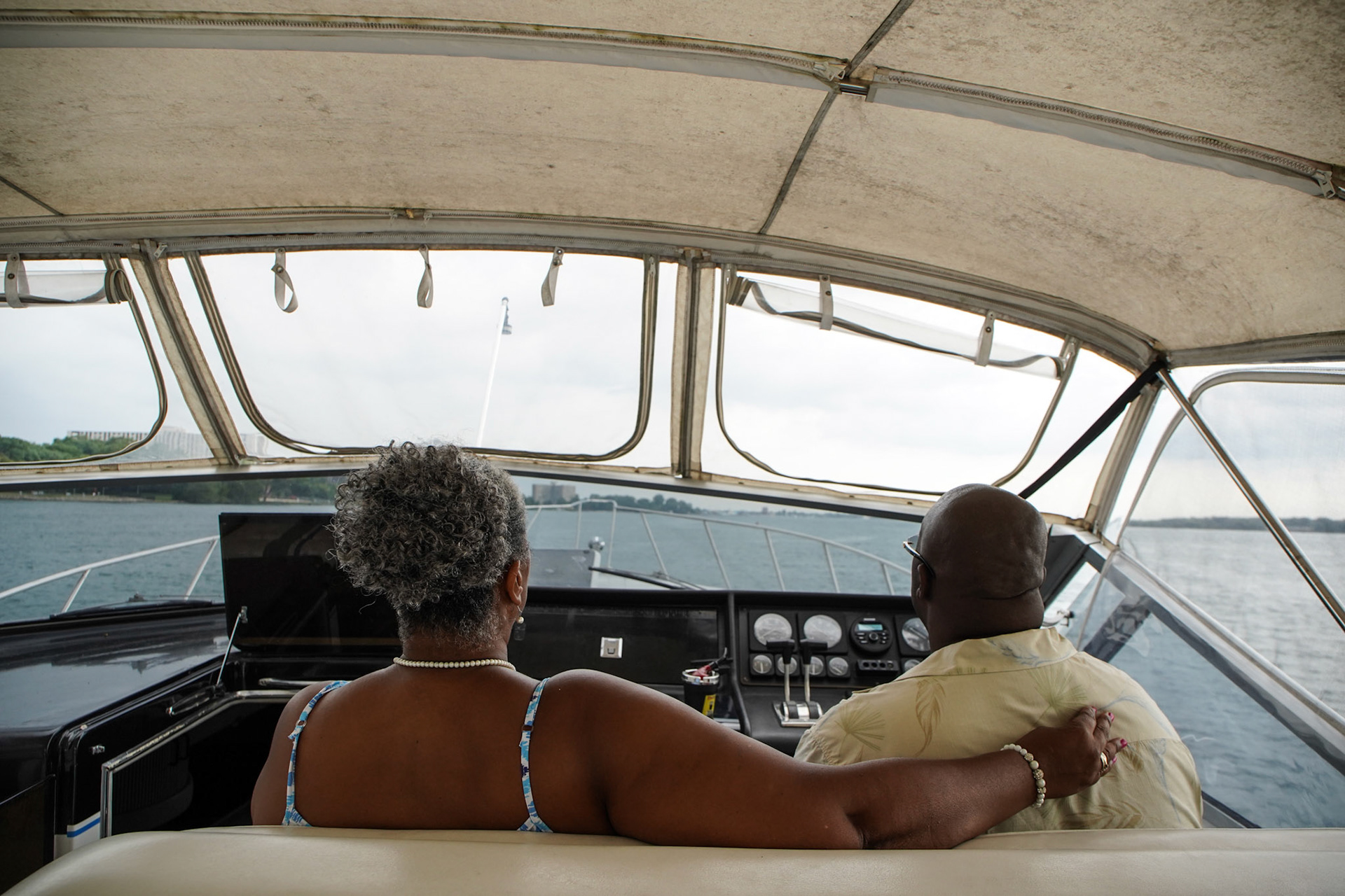 Terrisena Mccants, 53, of Detroit sits in the front of the boat with her husband, Raymond Mccants, 52, of Detroit as he drives the boat in the Detroit River in Detroit on Friday, August 27, 2021. Raymond Mccants II keeps his boat at Riverside Marina, a black owned marina in the city of Detroit.