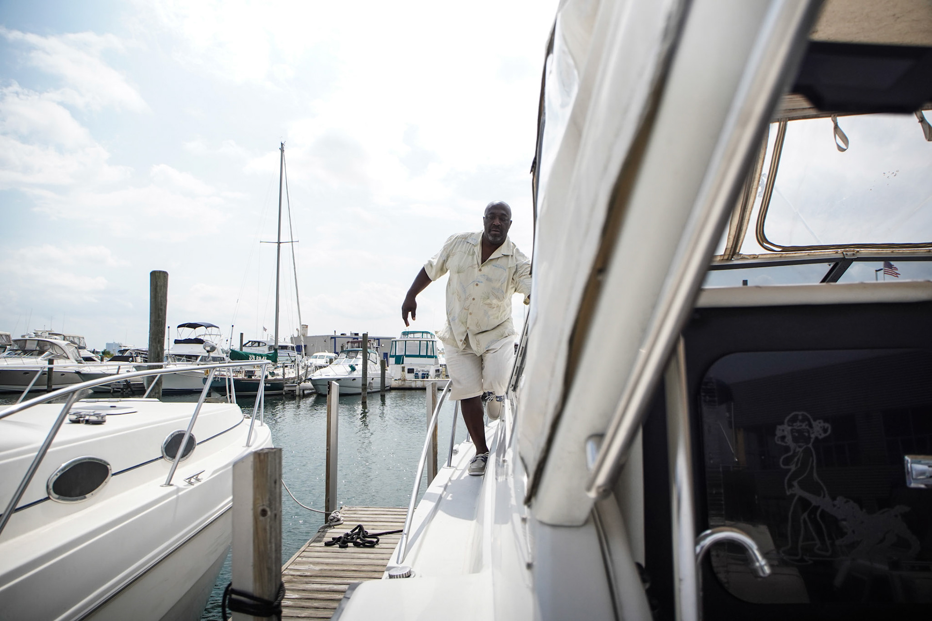 Raymond Mccants II, 52, of Detroit comes from around the boat as he gets ready to drive the boat from Riverside Marina in Detroit on Friday, August 27, 2021. Raymond Mccants II keeps his boat at Riverside Marina, a black owned marina in the city of Detroit.