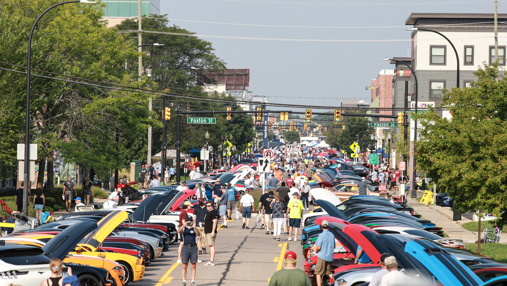 Spectators walk down Mustang Alley at the Woodward Dream Cruise in Ferndale on Saturday, August 21, 2021. The Woodward Dream Cruise, the world's largest one-day car event returns after taking a break last year due to COVID-19.