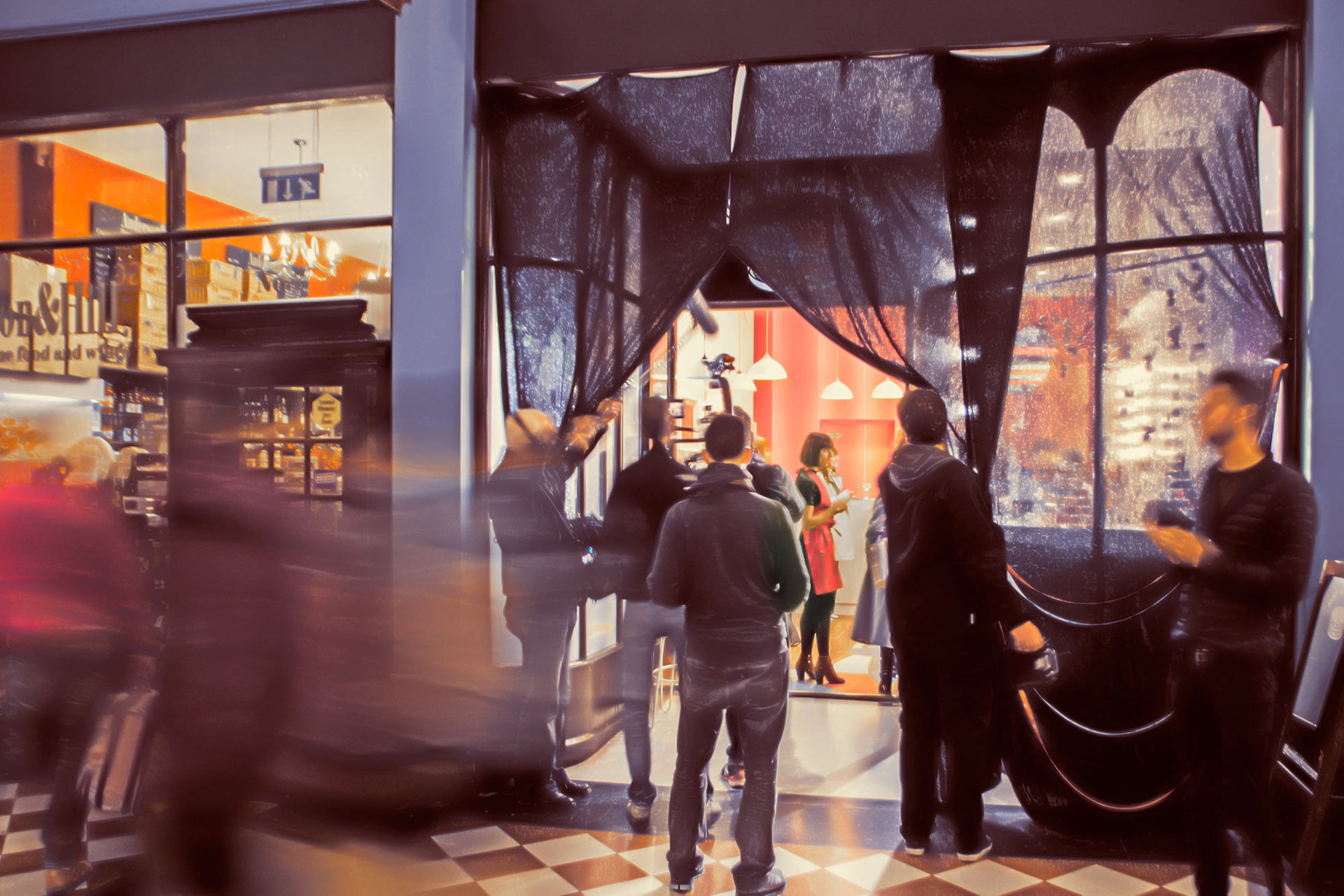 People gather at a shop entrance with sheer curtains, some in motion, creating a bustling, lively atmosphere. Inside, warm lighting reveals a vivid red wall.