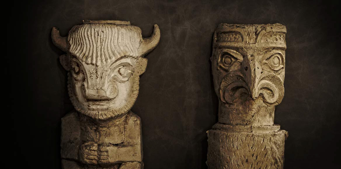 Interior photography of antique room set by Simon Donnelly Photographer Birmingham two masks white carved in wood sit side by side