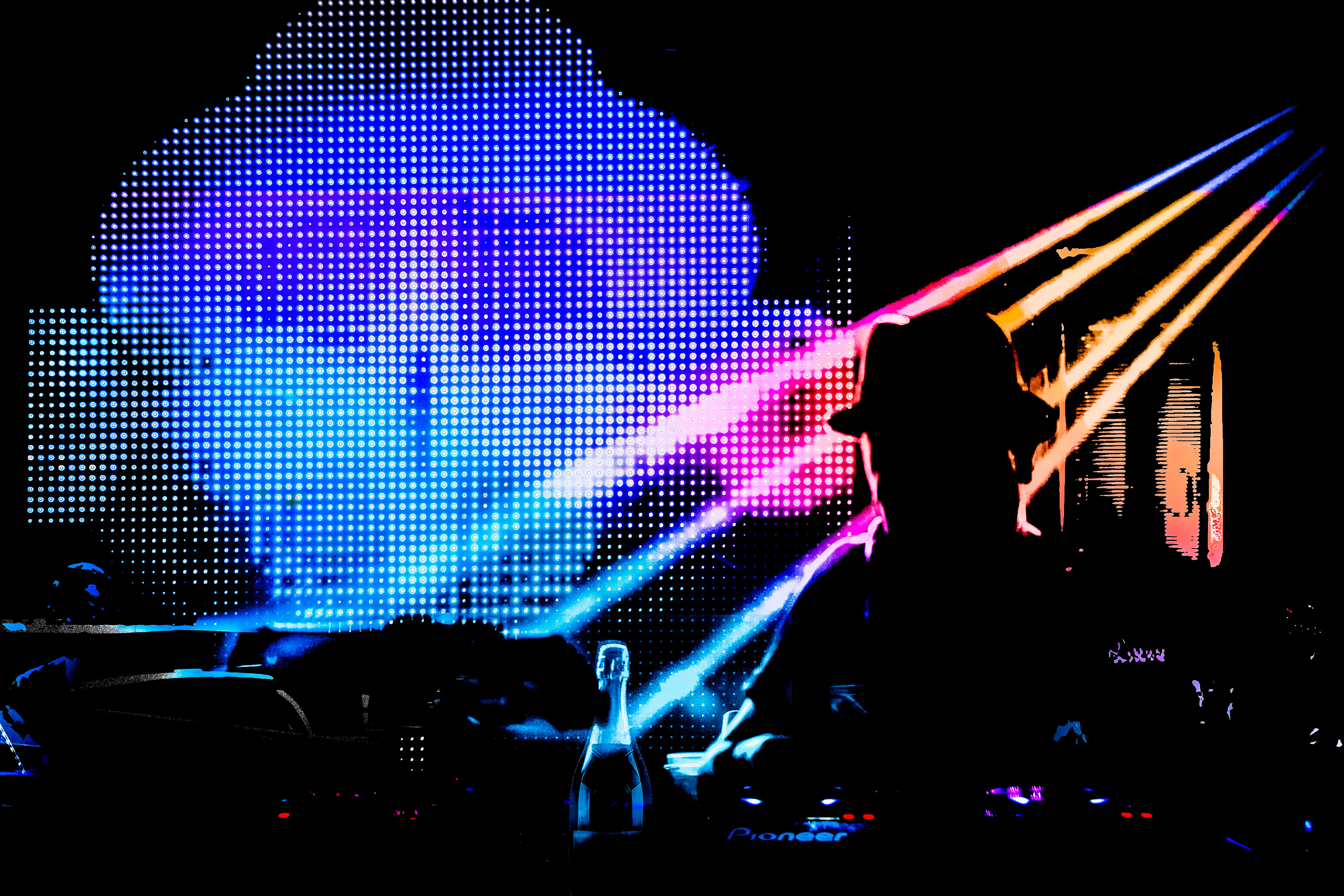 A silhouette of a person in a hat is set against a vibrant background of blue, pink, and purple digital dots. The mood is energetic and lively.