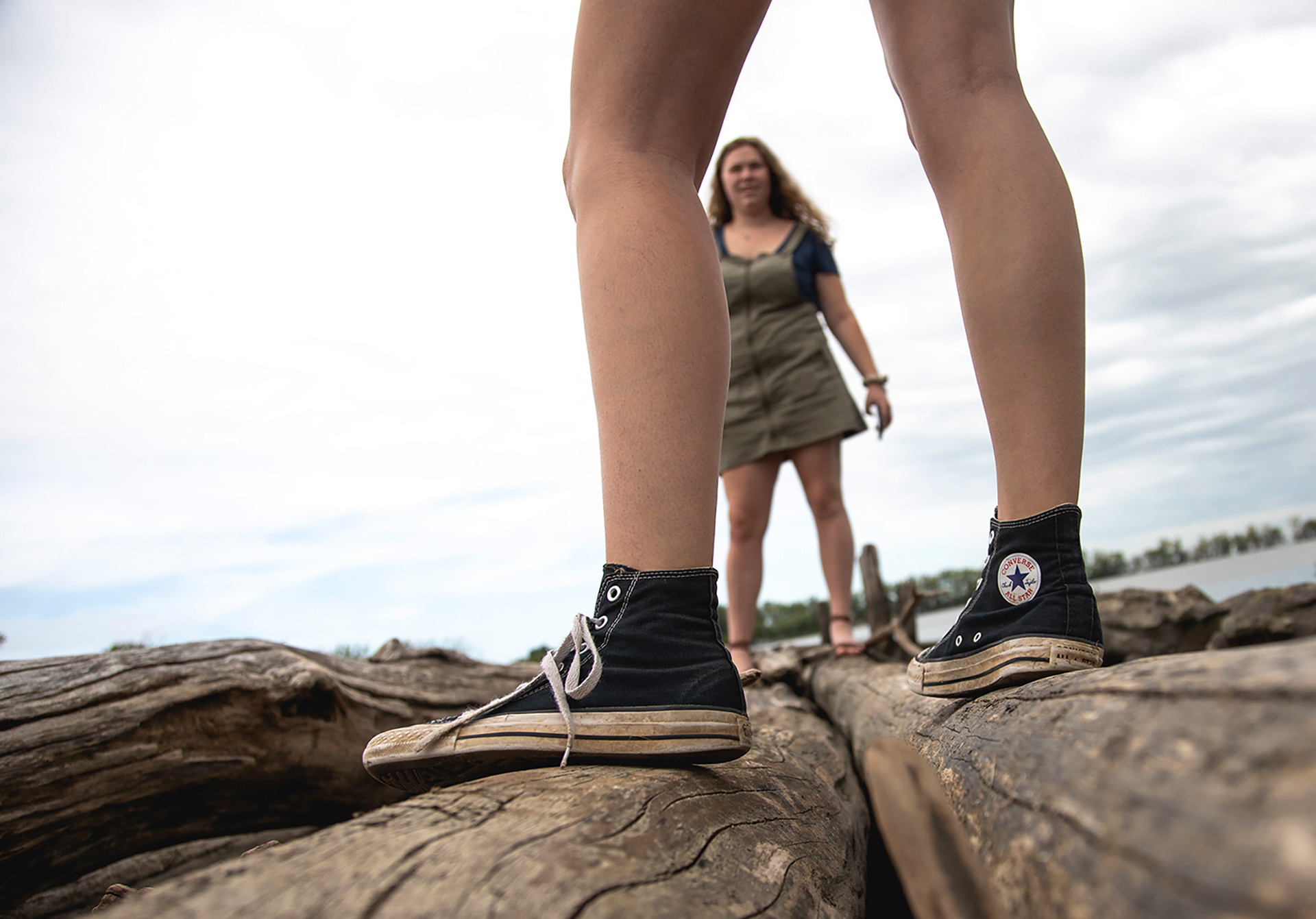 My roommate Maggie Bennink stands on a log and talks to me as we explore a section of shore on Lake Michigan while visiting a friend in Toledo, Ohio.