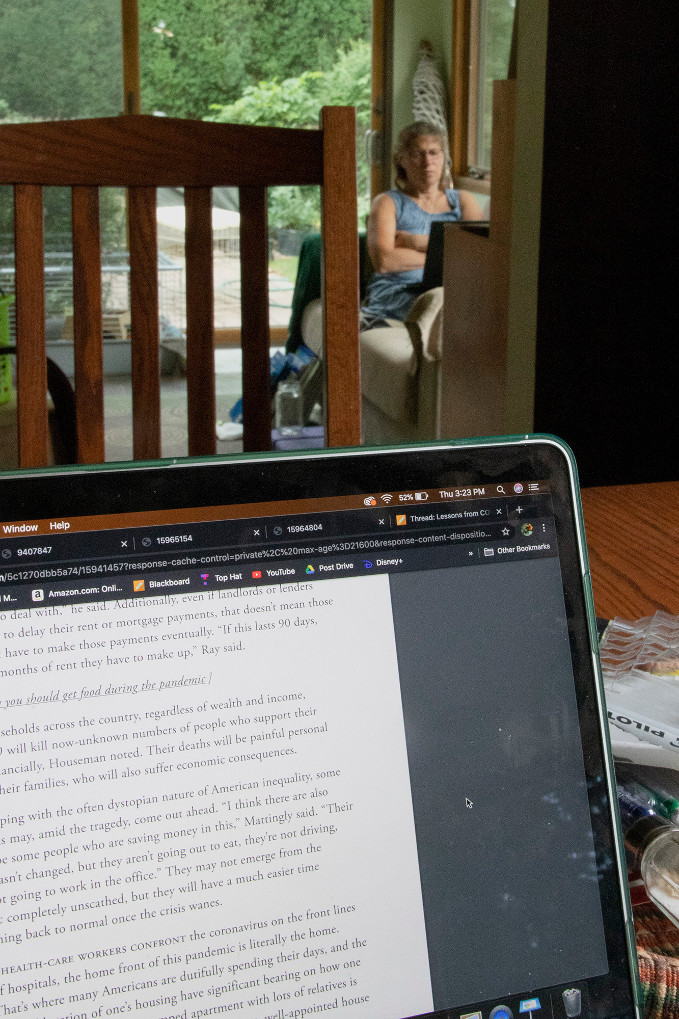 Marie Boozer, a fourth grade teacher preps for her virtual class to start in her makeshift workspace as I work on my own class work in a nearby room.