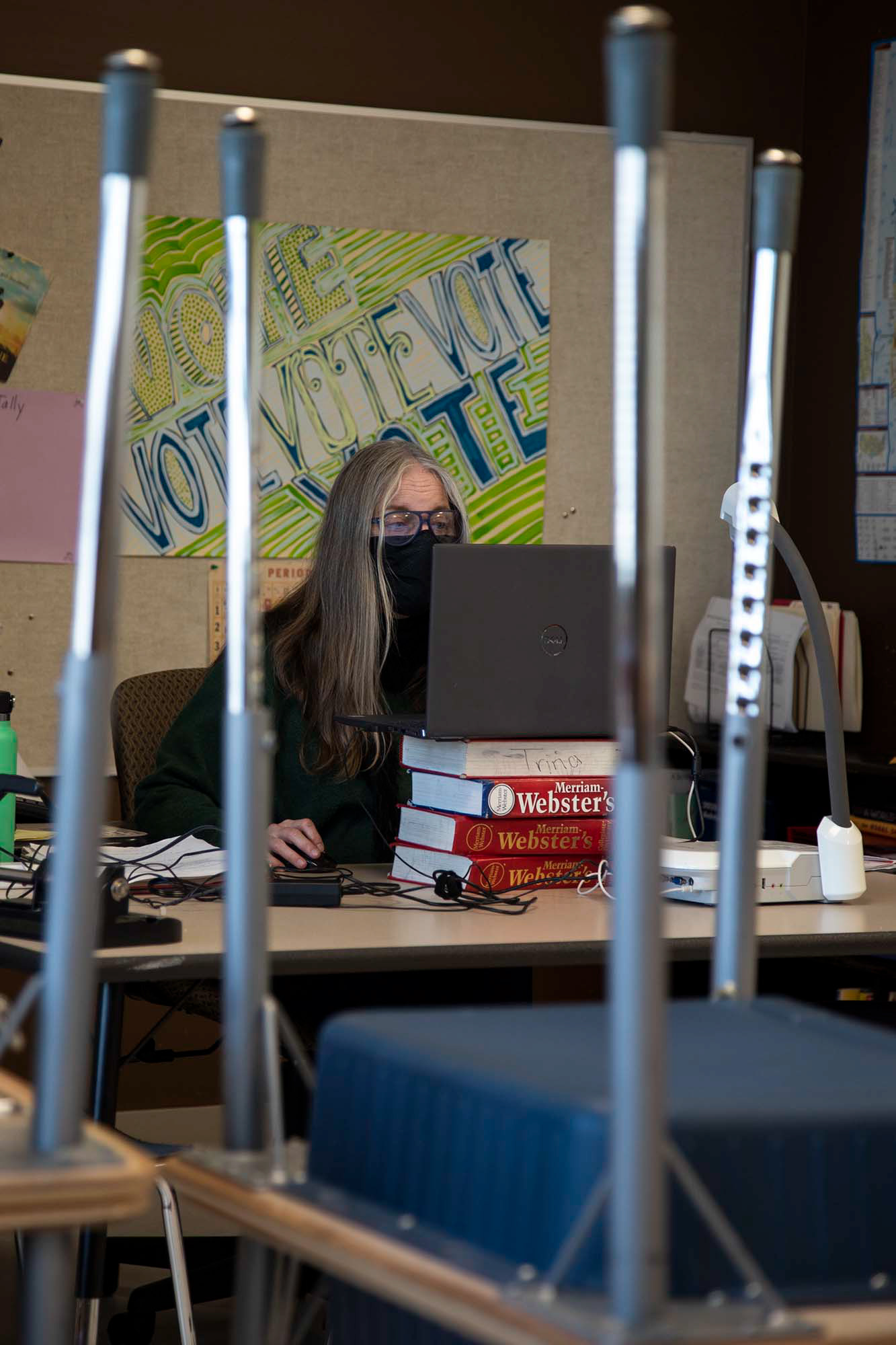 Trina Marschall discusses work with her class through upside down desks. Much like Marschall, many teachers have had to remove furniture in their classrooms so that desks can be six feet apart. Marschall previously used tables and couches, so desks will be a big adjustment for her and her students.
