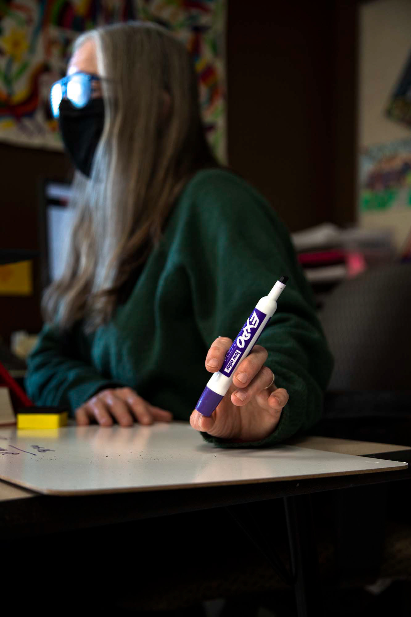 Trina Marschall uses her Elmo device to write out math problems on a white board. Normally this would be done on individual white boards and then as a class, however due to supply shortages at home, the students are not able to do this so Marschall has to adapt and show the process herself.