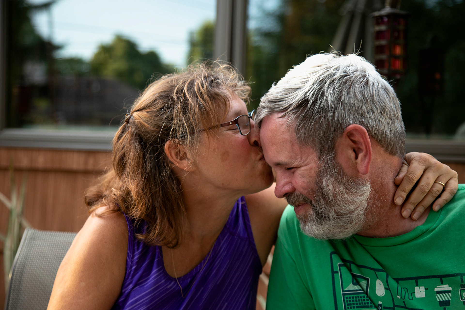 Marie Boozer, left, kisses her husband, Jim Legg, right, on the forehead as a sign of affection. Boozer and Legg have been married for over 25 years and say that each year gets better and better.