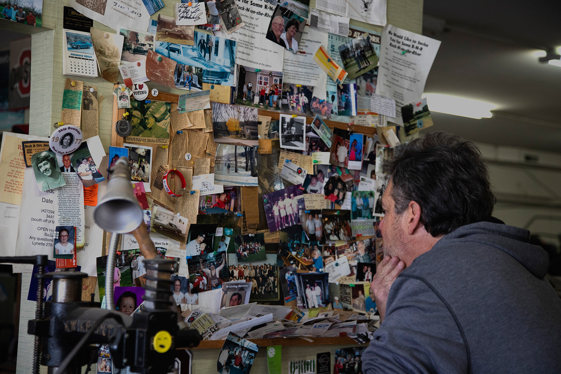 Skip Bowman looks at old photos and keepsakes of his family and the shop on a wall inside Beck and Orr in Columbus, Ohio, on Friday, Oct. 29, 2020. He claims people should “cherish moments with your parents” as he has done while working with his father.