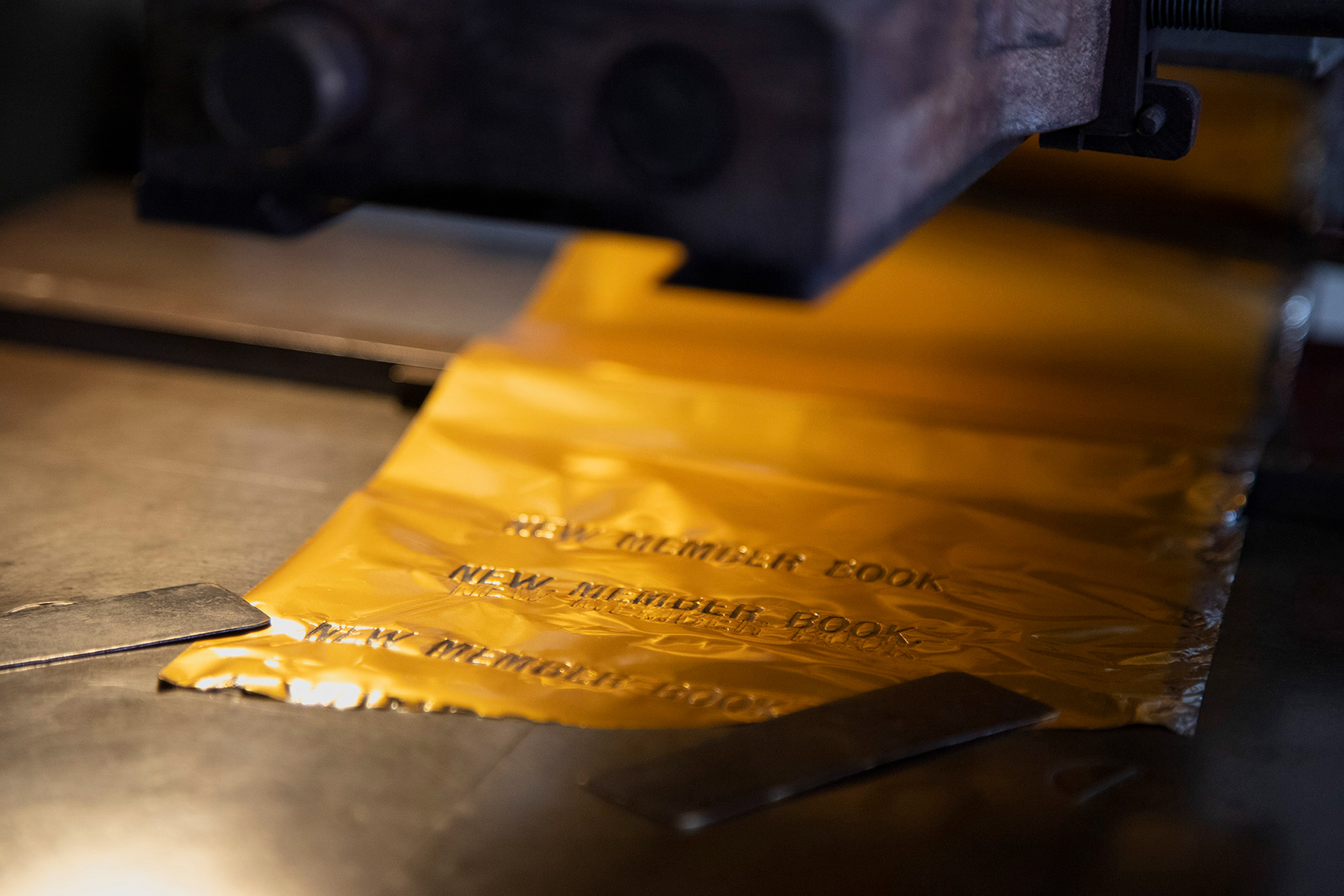 After making the perfect cover for books, gold letters can be stamped onto it, as in this new member book for a fraternity. Each stamp is checked for spelling, the right amount of heat, and placement before it is carefully imprinted on the covers.