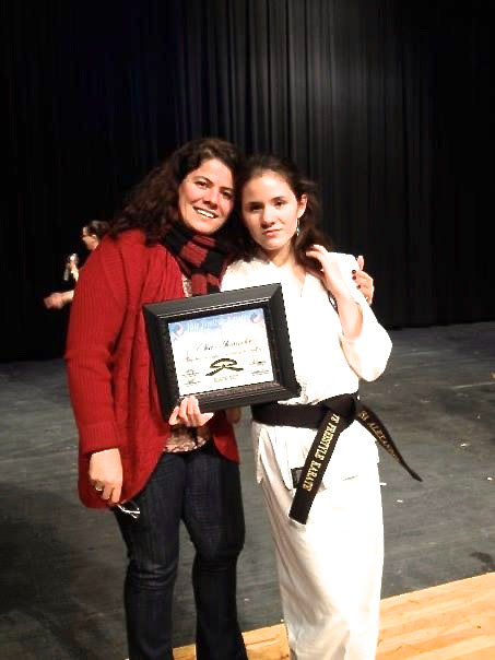 My mother and I at the ceremony after I achieved the rank of black belt in freestyle karate.