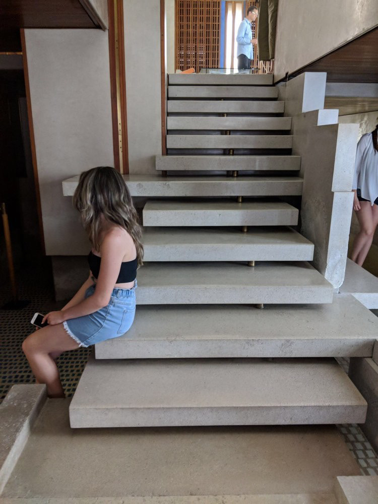 Sitting on the steps of Carlo Scarpa's Negozio Olivetti in Venice, Italy. In the background you can see my professor, Peter Wiederspahn, admiring the Barcelona Chairs on display at the top.