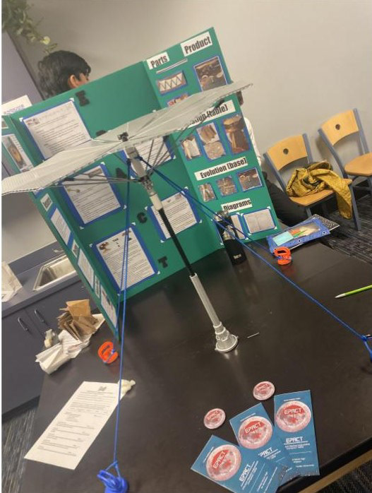Our final prototype next to our Tri board, brochures, and pins!