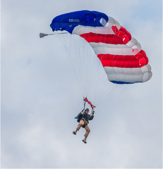 Skydiver approaching 18th Green at Opening Party.