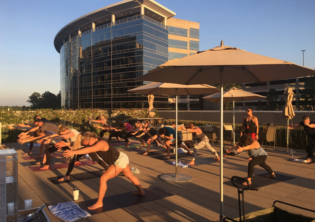 Lululemon sponsored yoga event on rooftop celebrating Global Wellness Day.