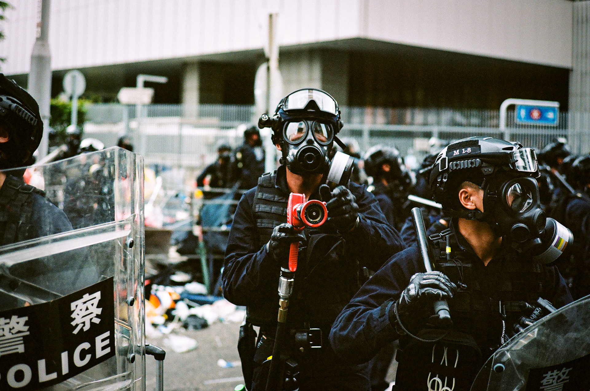A riot officer stands with his high pressure pepper spray hose at the ready. Citizens of Hong Kong have taken to the streets in order to fight a new proposed law, that would allow for Hong Kongers arrested in the city to be extradited to China. June 12, 2019 - Hong Kong, 35mm
