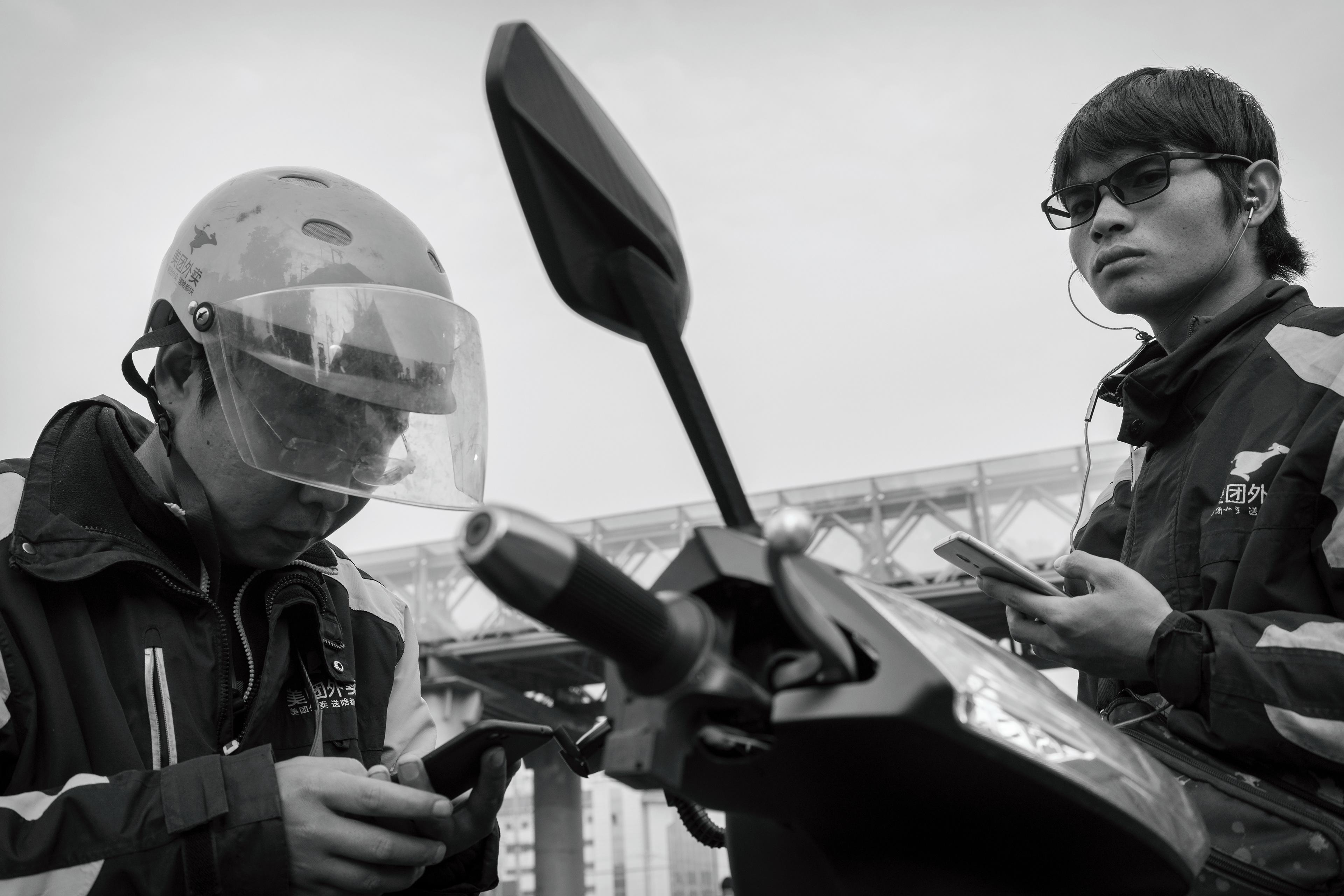 Break time for two food delivery guys.