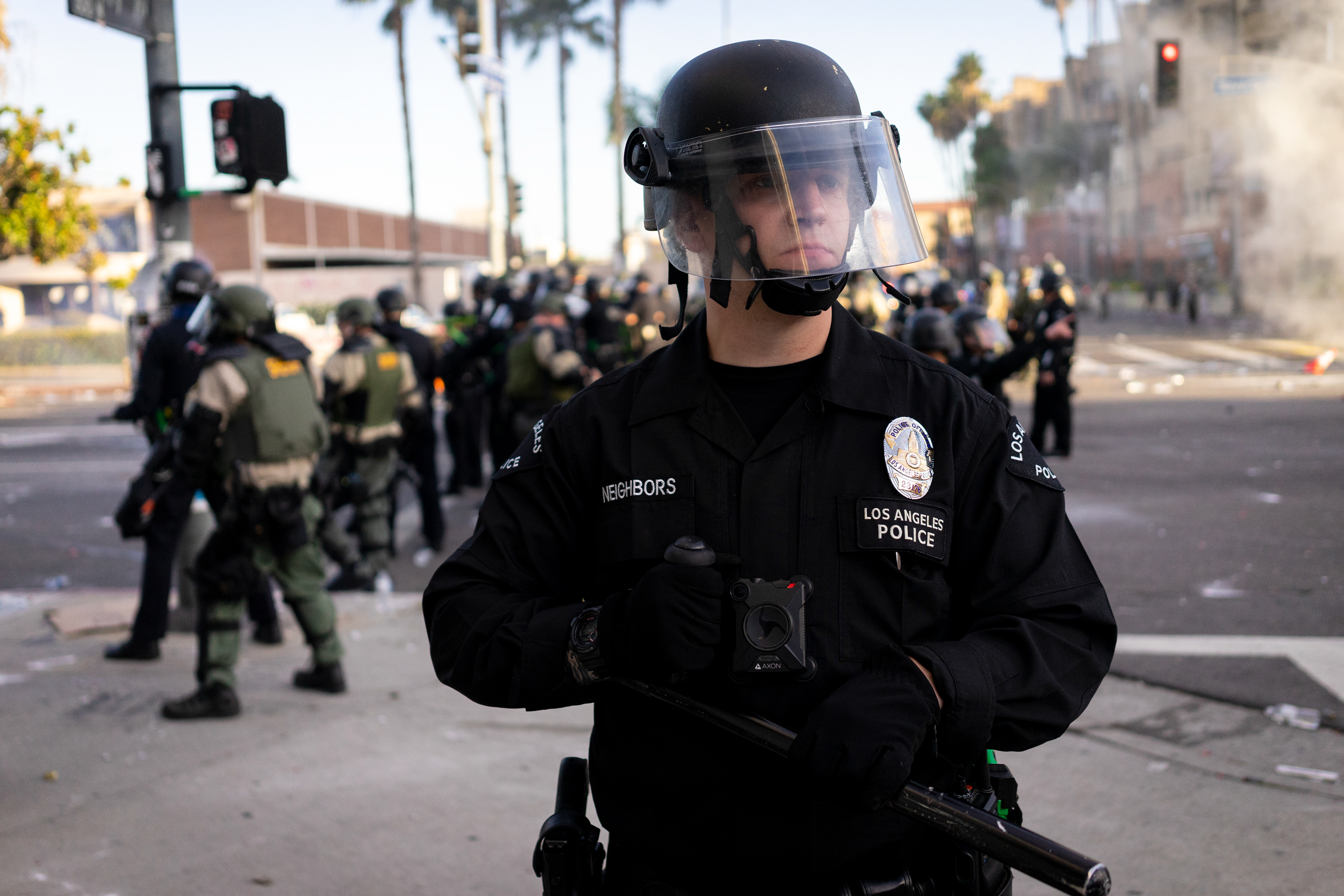 With Neighbors Like These: Fairfax, Los Angeles - The unfortunately named Officer Neighbors holds a position at the corner of Beverly and Stanley as his colleague's fire on protestors with tear gas grenades and pepper balls. Angelinos took to the streets to protest continued police violence and murder in the wake of George Floyd's murder by Minnesota Police on May 25th. May 30, 2020-Los Angeles-Photo by Aaron Guy Leroux/ Sipa USA