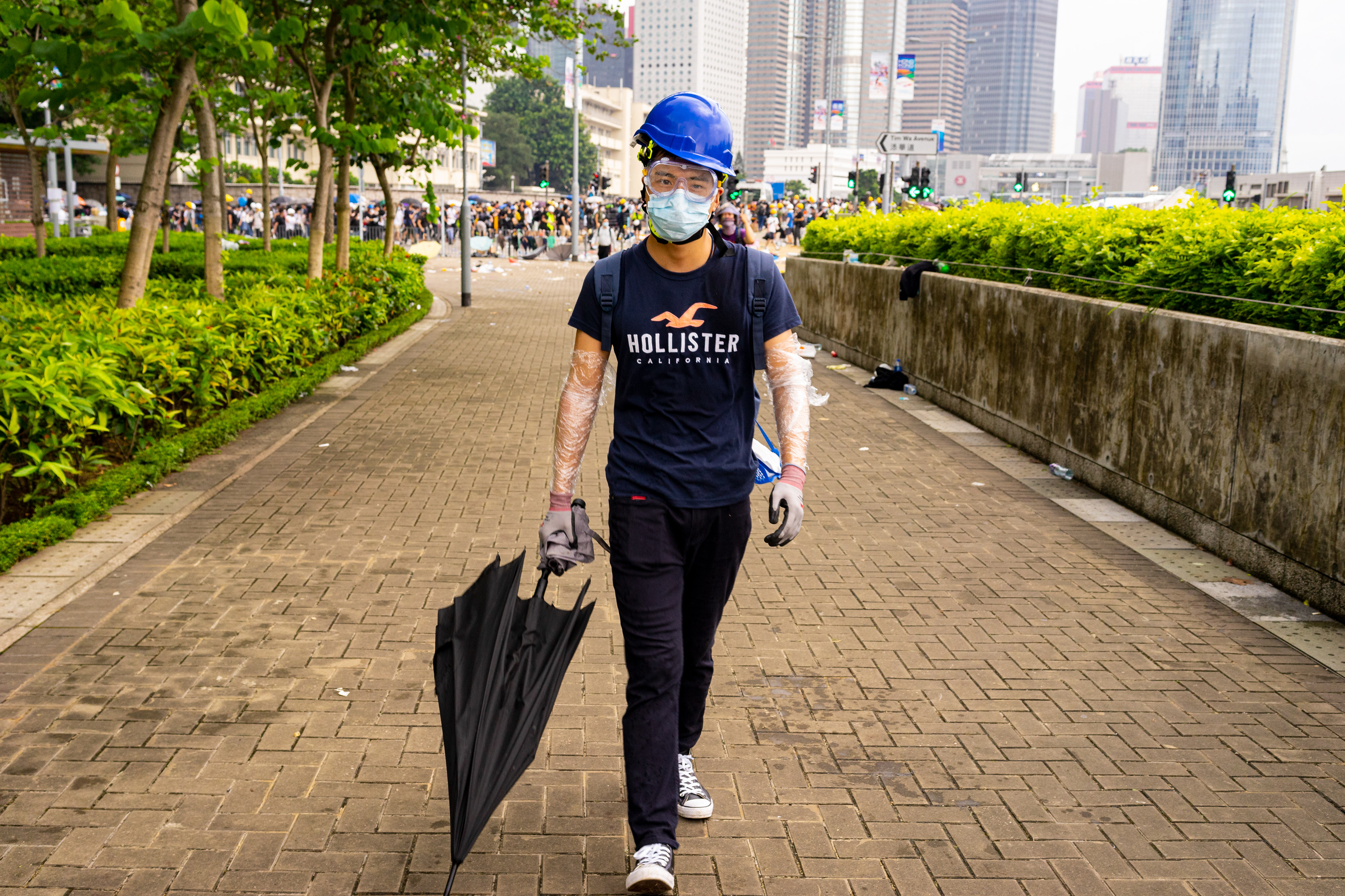 A protestor takes the long way around a deployment of tear gas, to head back to the main protest sight in Admiralty. Protestors in Hong Kong take to the streets again. This time to fight a new proposed law, that would allow for Hong Kongers arrested in the city to be extradited to China.