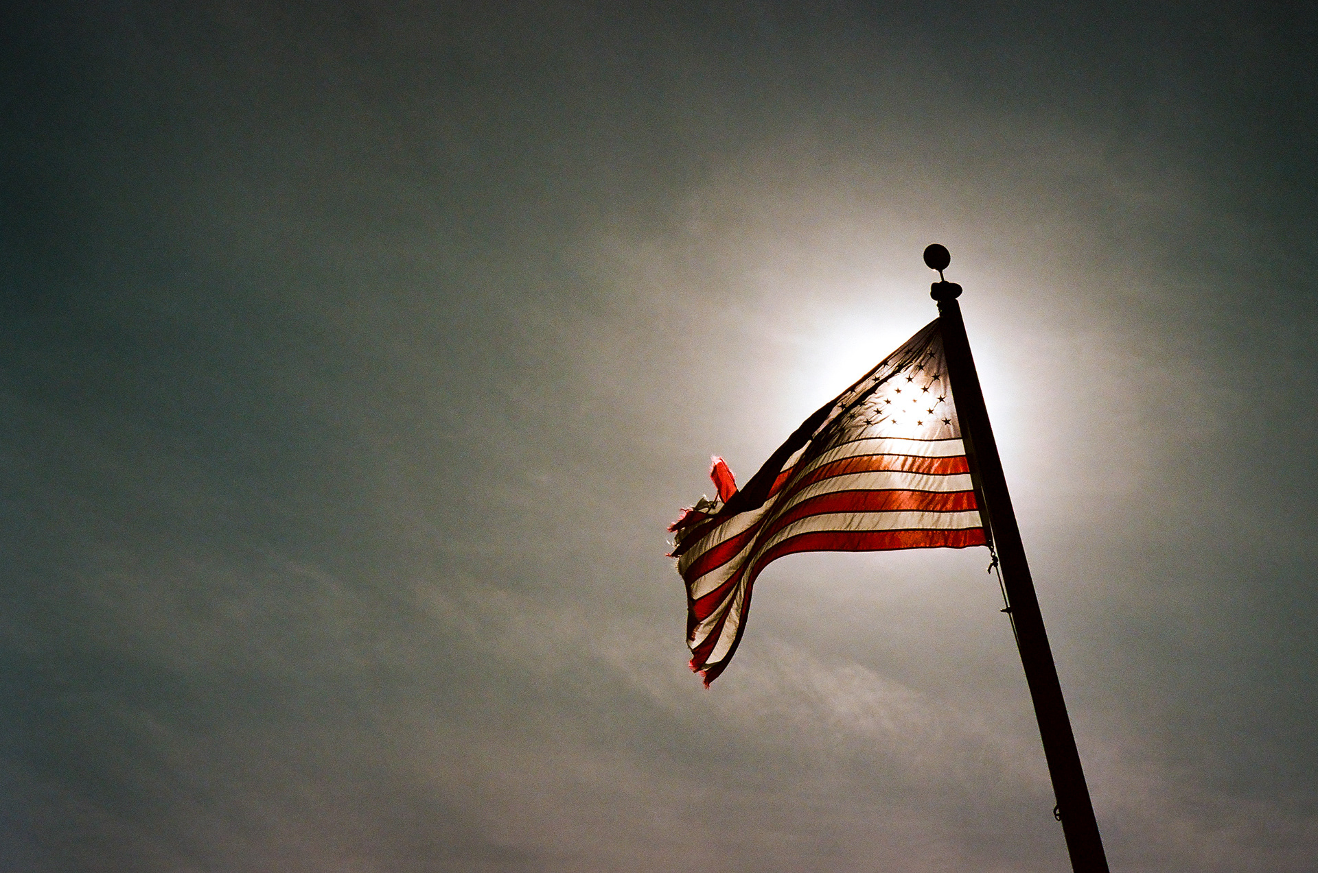 Winter Flag: The U.S. flag, tattered, flying over Winter Island in Salem, Mass. November 2020-Salem, MA-Photo by Aaron Guy Leroux